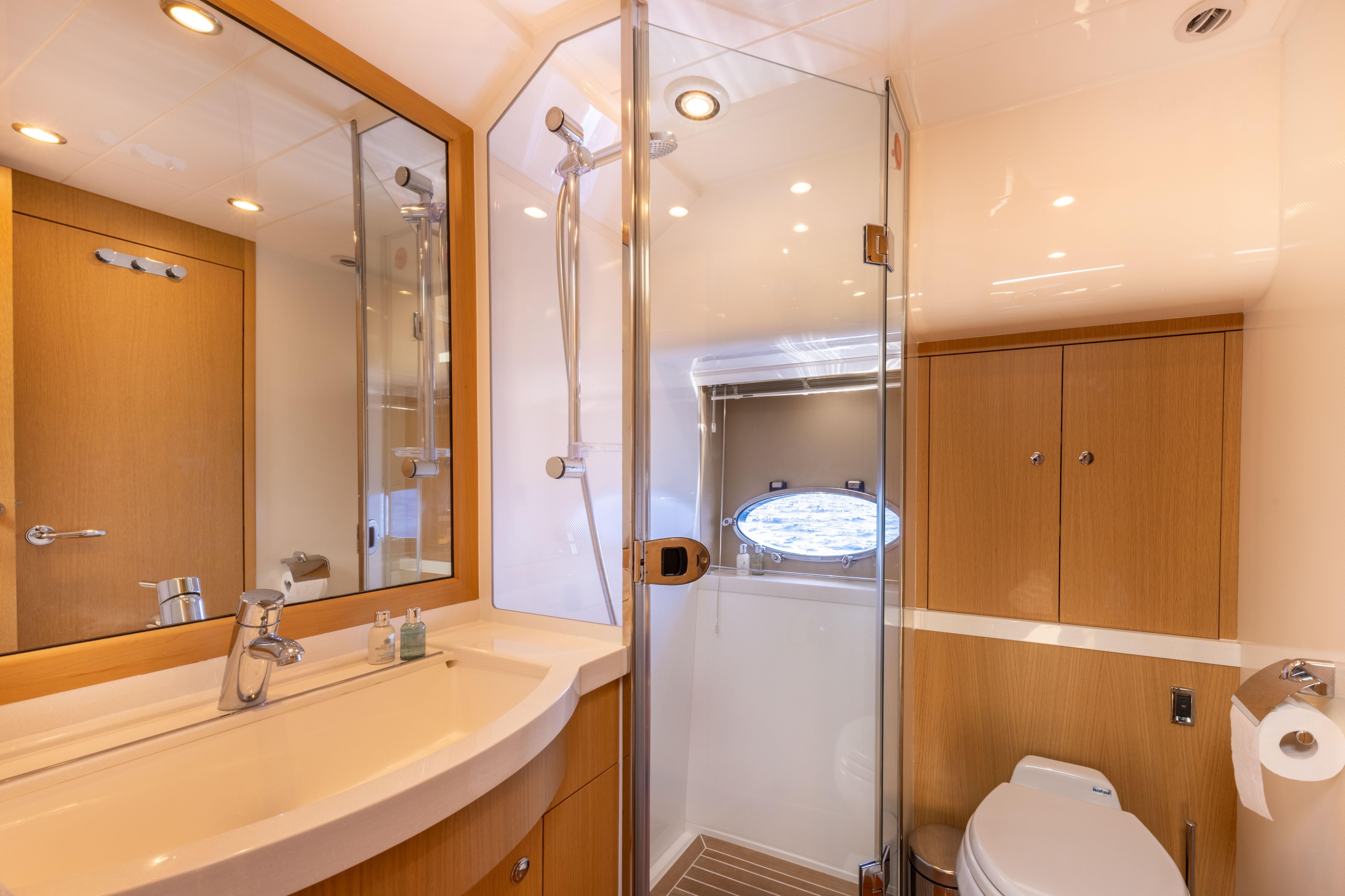 Luxurious 2008 Princess V70 yacht bathroom with modern fixtures and elegant wood accents.