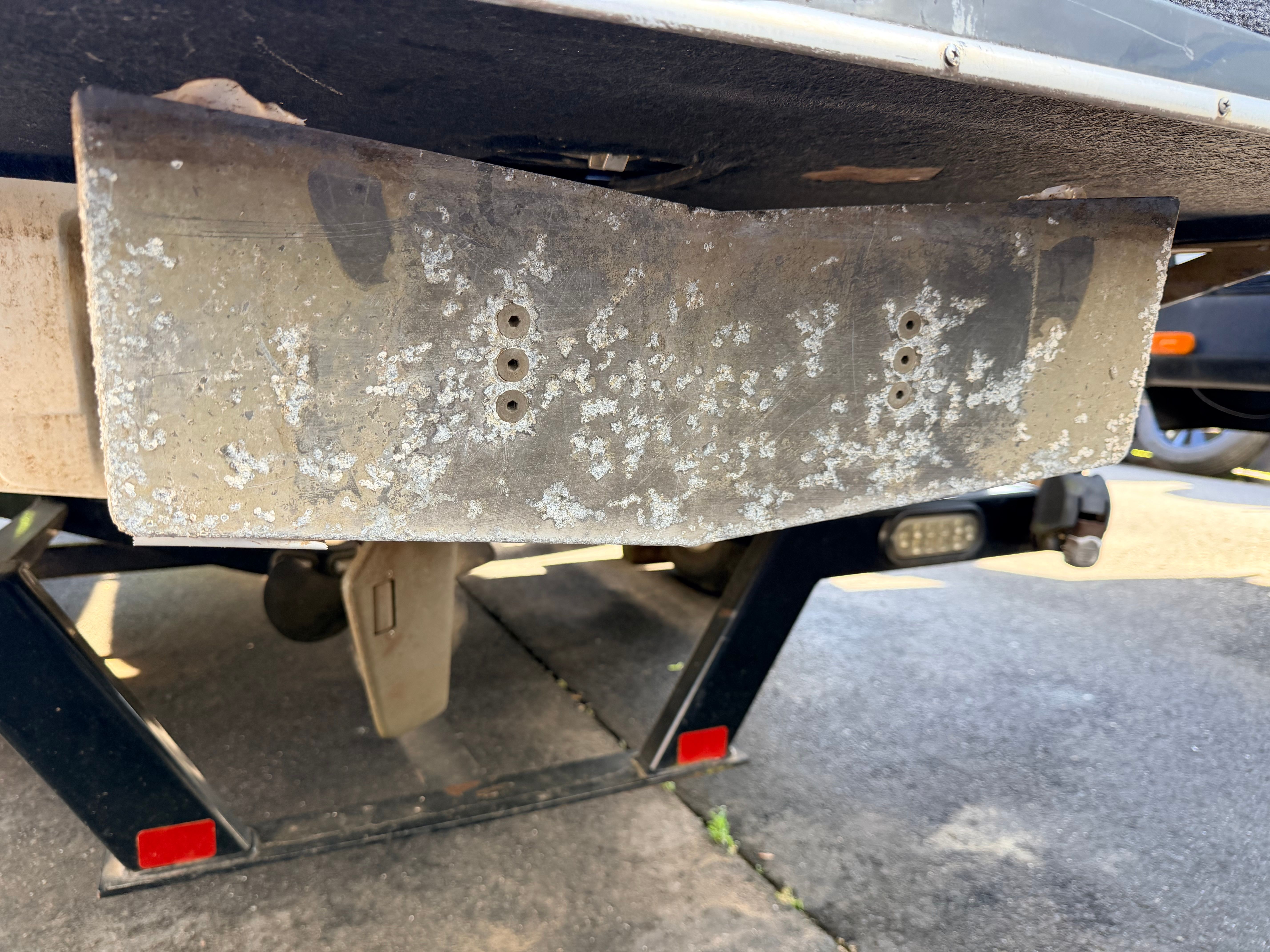 Close-up of a 2006 Malibu iRide boat part on a trailer.