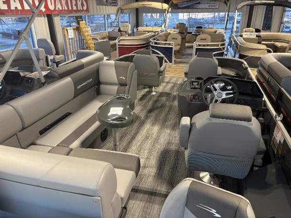 2025 Bennington 21 SF pontoon boat interior with gray seating and modern dashboard.