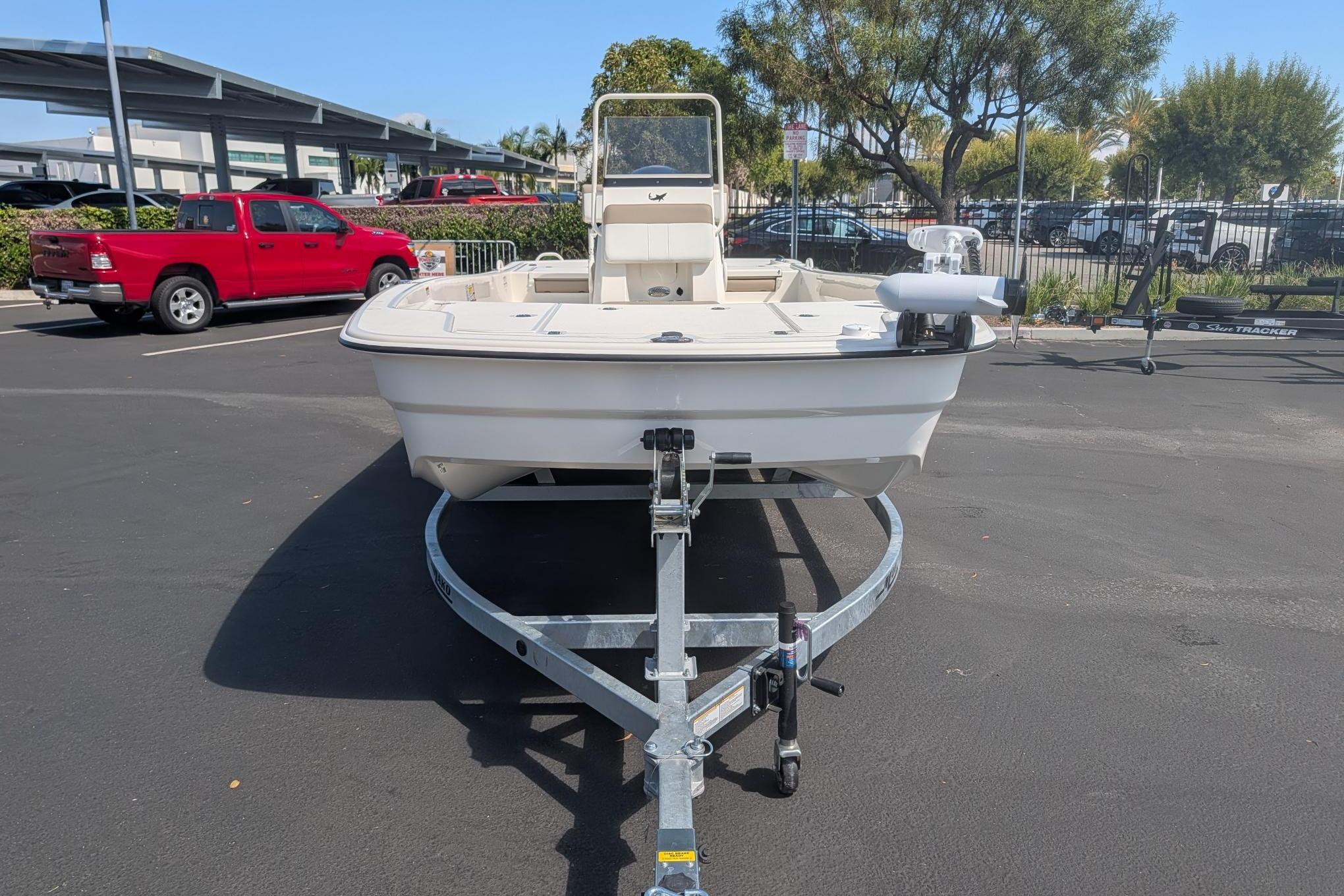 2026 Mako Pro Skiff 19 CC boat on trailer in parking lot.