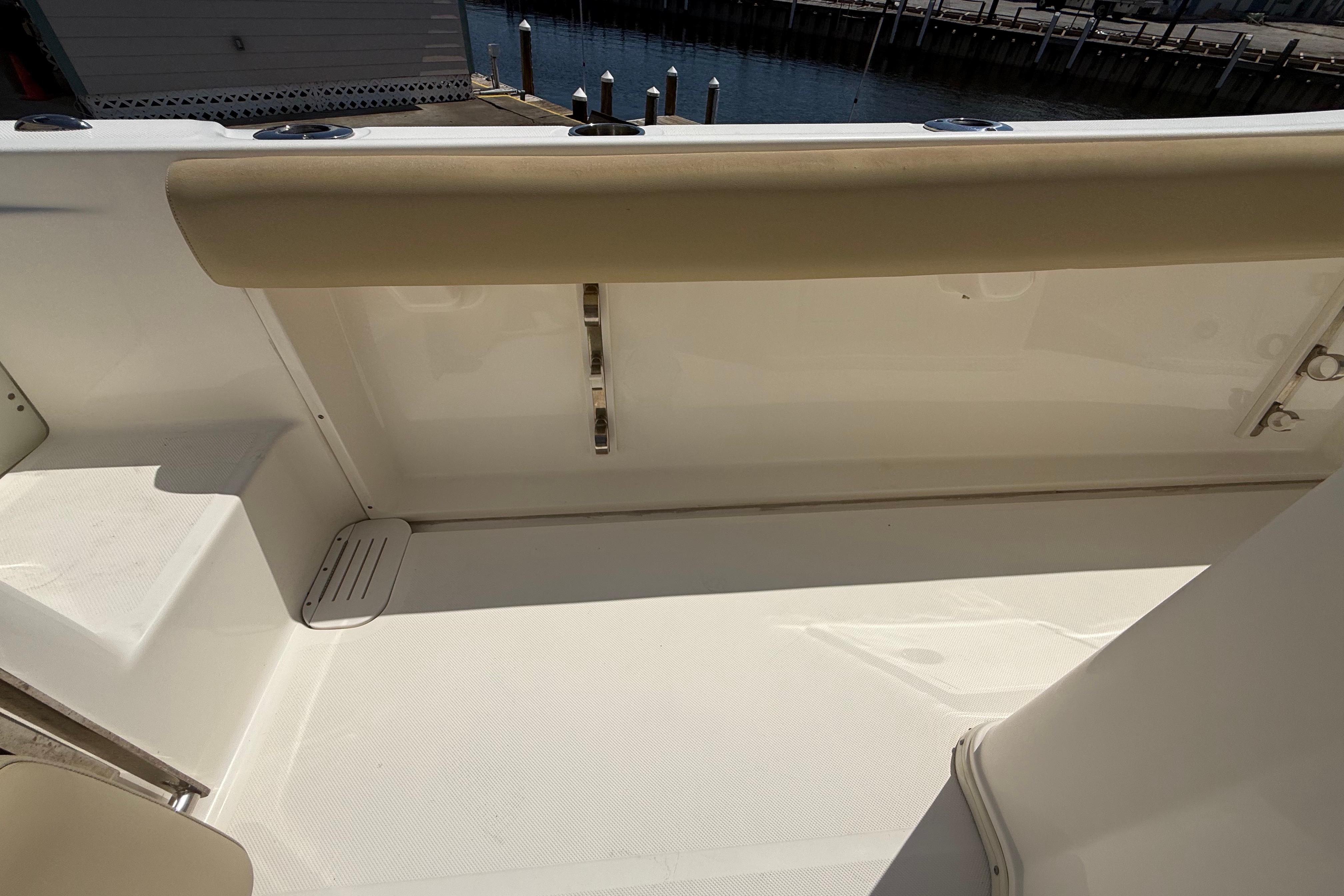2019 Key West Billistic 281 Center Console interior with beige seating and white deck.