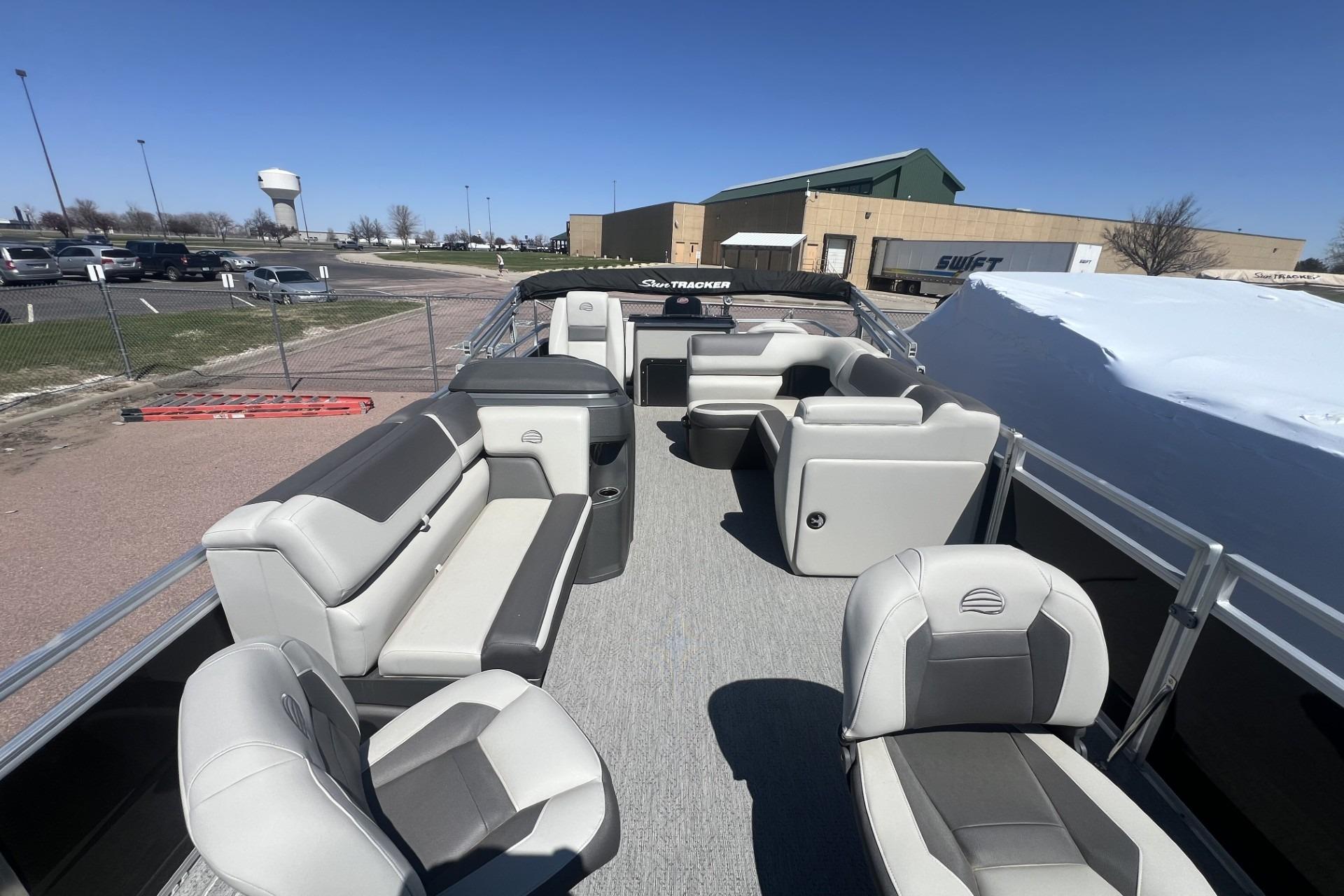 2026 Sun Tracker Fishin' Barge 20 DLX pontoon boat with spacious seating and modern design.