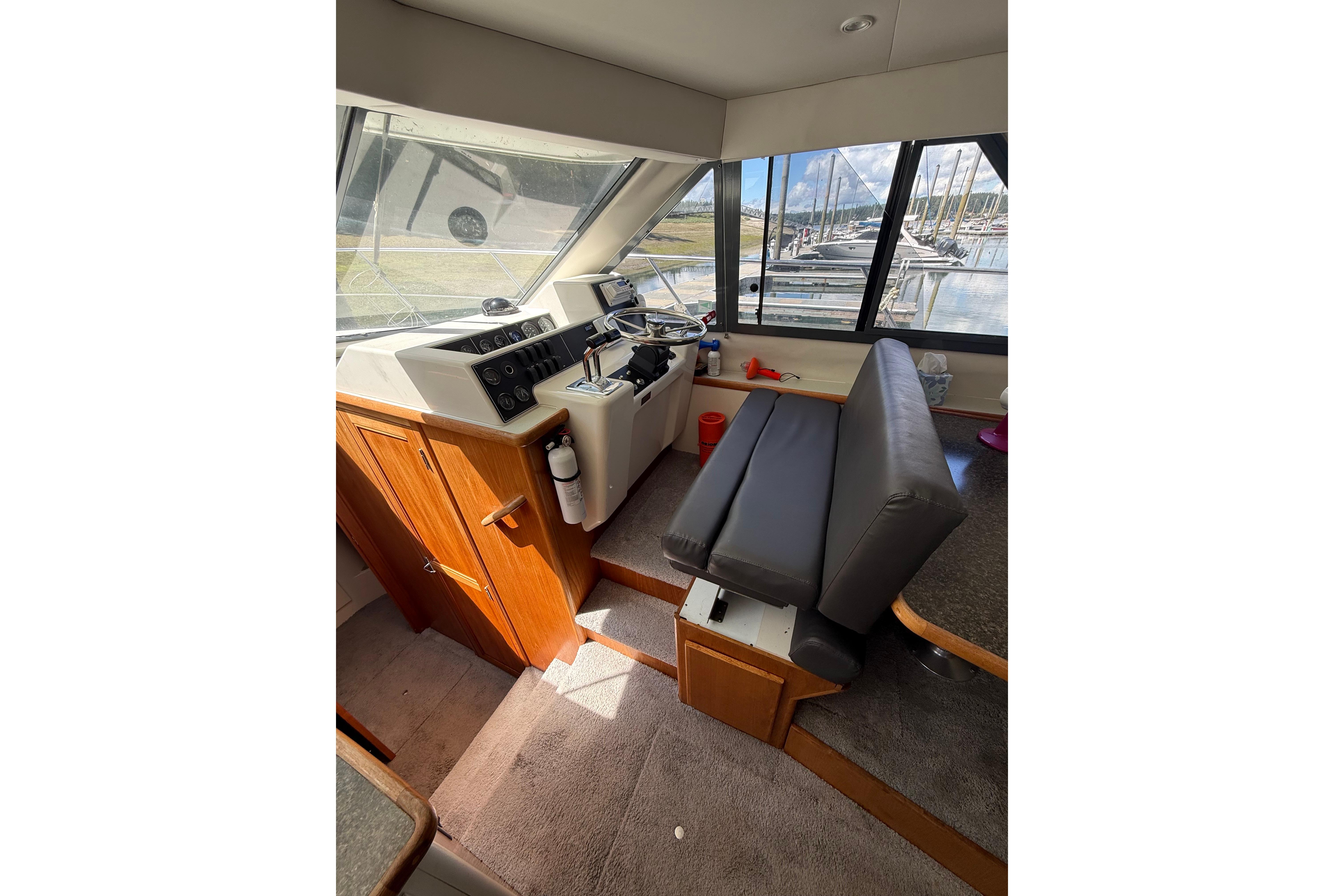 Interior of 1995 Carver 370 Voyager yacht with helm and seating area.