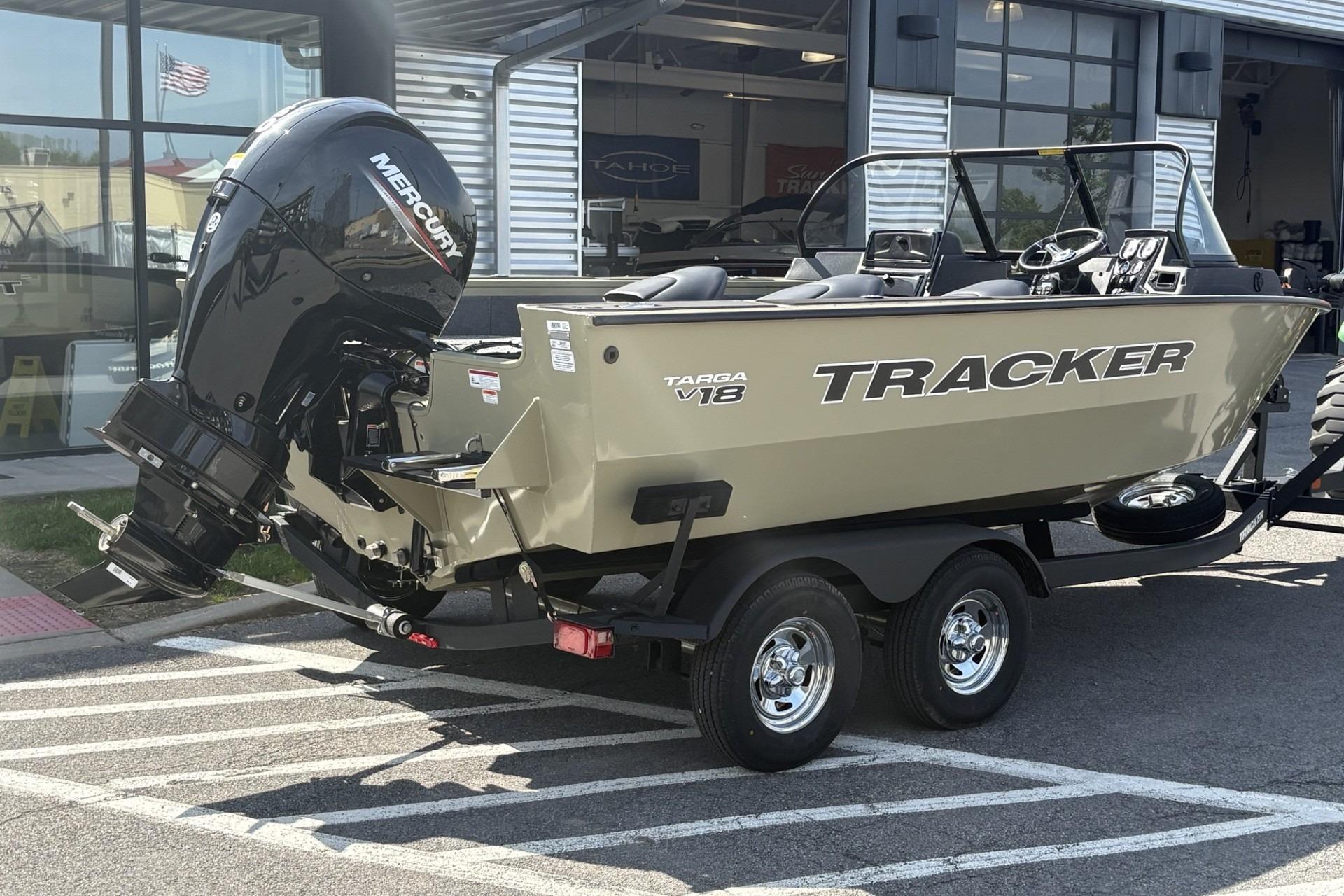 2026 Tracker Targa V-18 Combo boat with Mercury engine on trailer outside dealership.