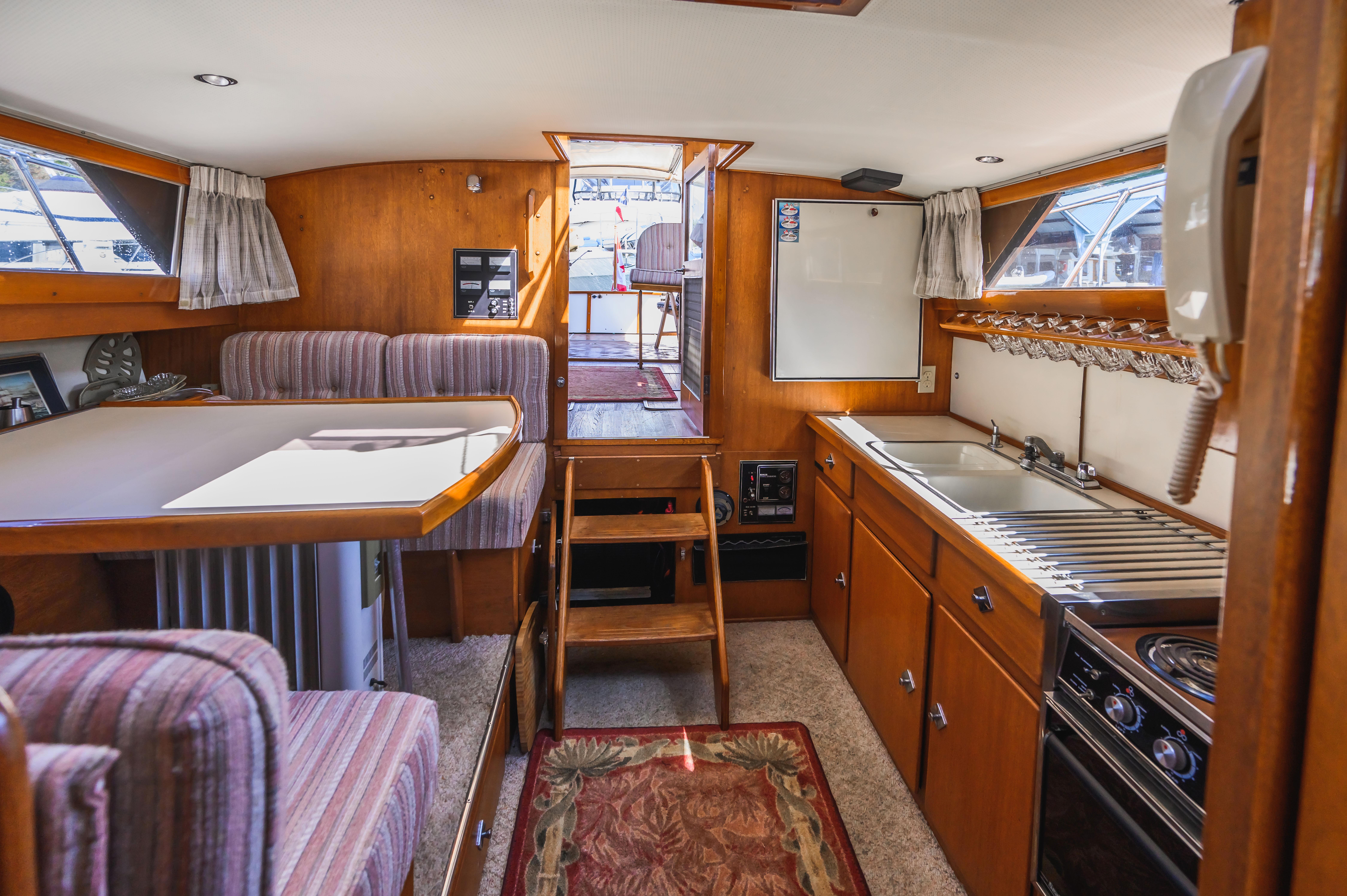Interior of 1968 Trojan 3700 Sea Voyager with kitchen and seating area.