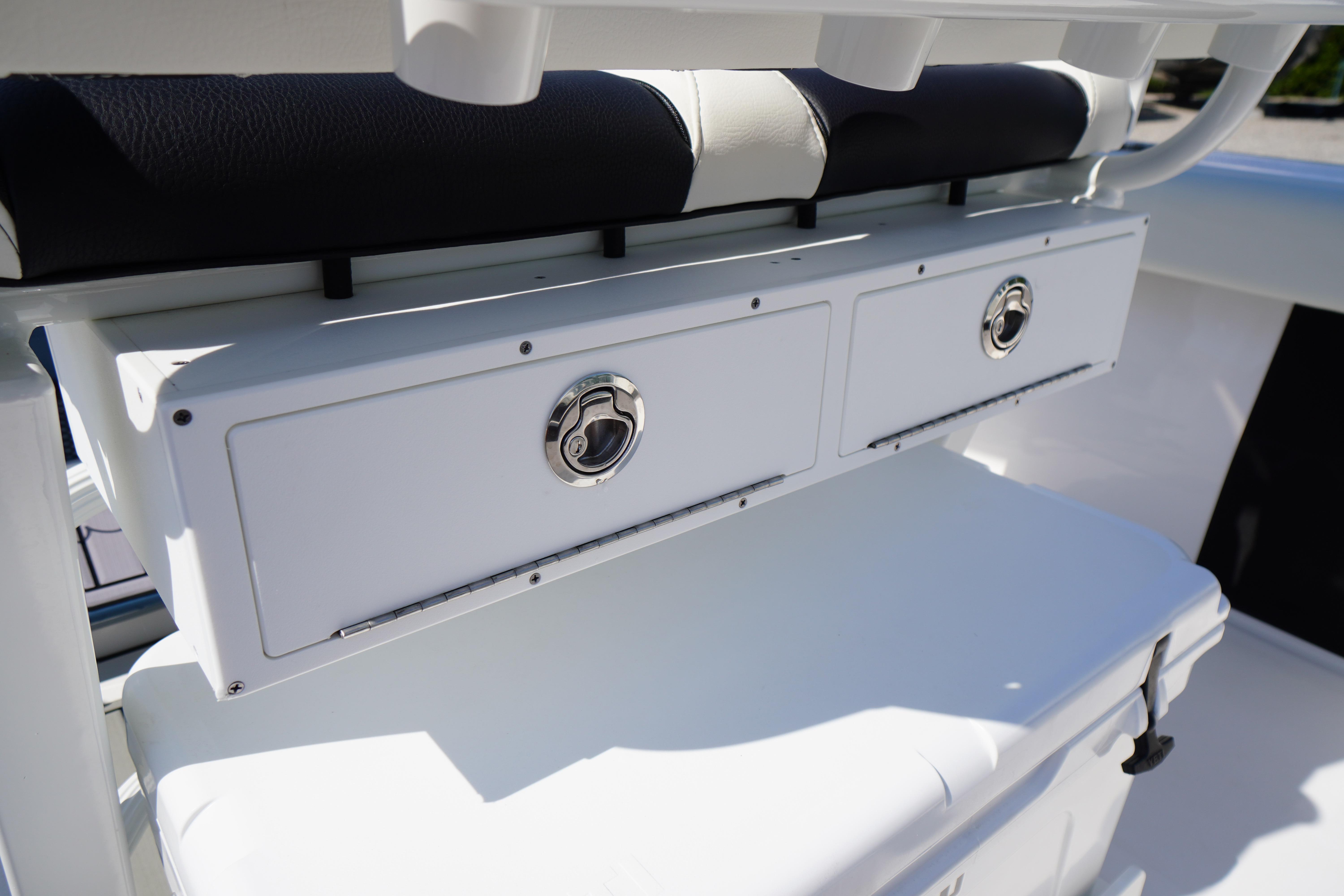 2025 Tidewater 232 SS boat storage compartments with sleek design and chrome handles.