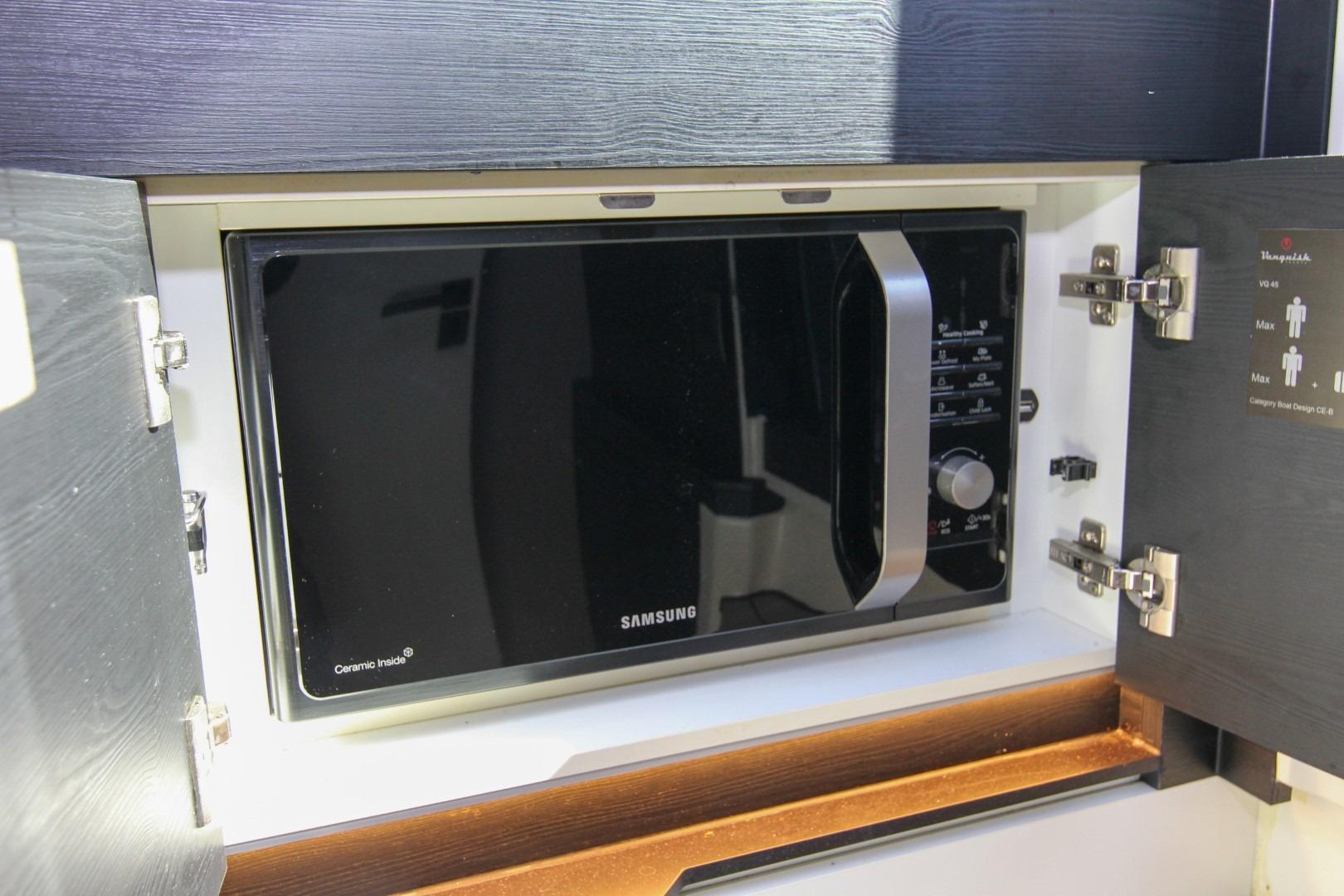 Built-in Samsung microwave in 2022 Vanquish Yachts VQ45 kitchen cabinet.