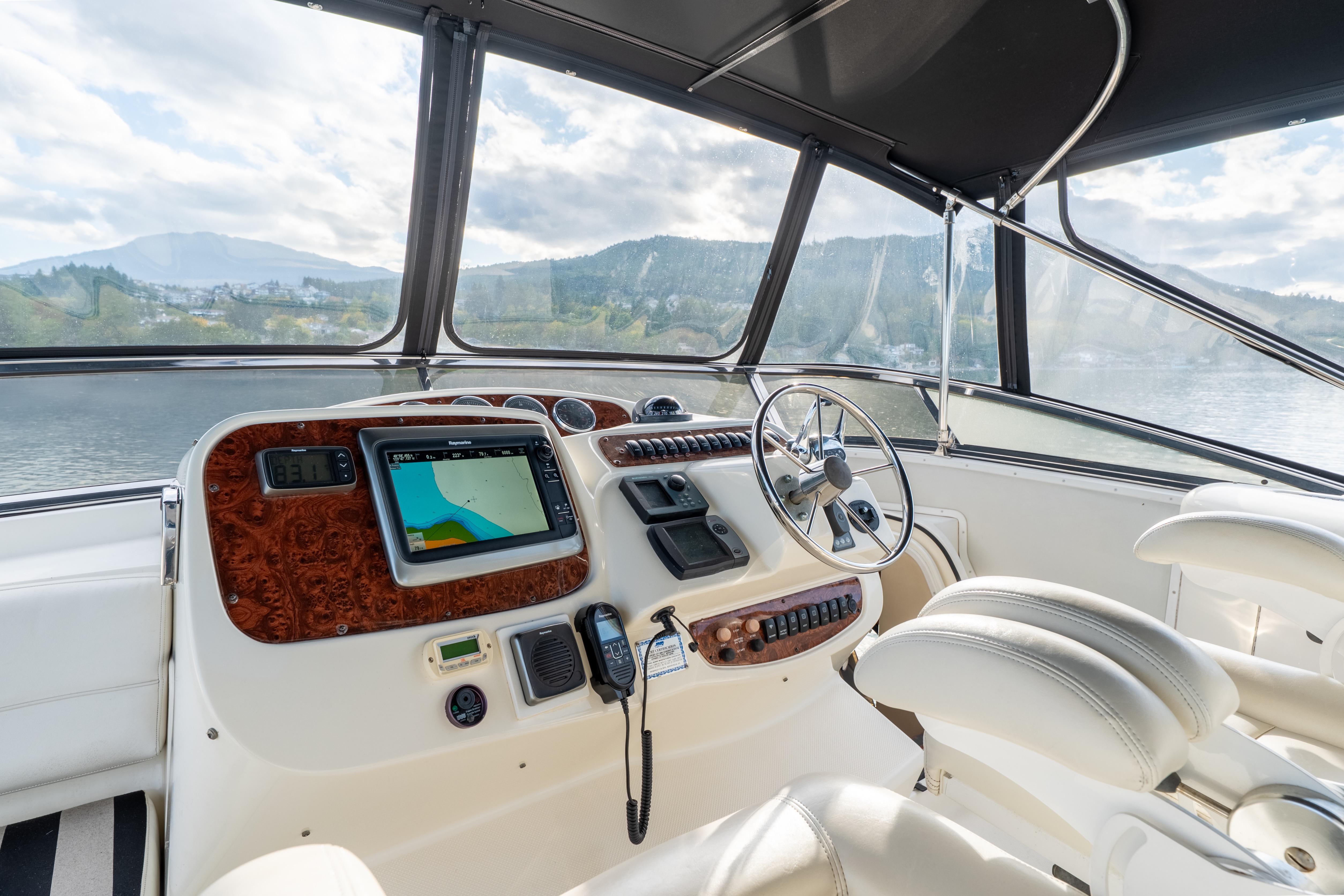 Pilothouse interior of 2007 Meridian 580, featuring navigation equipment and luxurious seating.