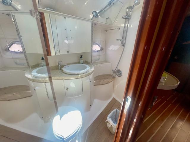Luxurious bathroom in 2011 Regal 46 Sport Coupe yacht with dual sinks and shower.