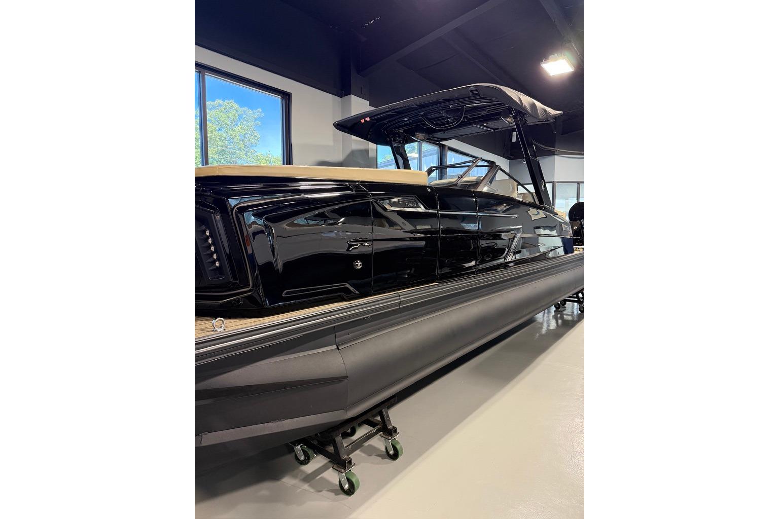 2026 Balise Halo 26C Twin boat displayed indoors, showcasing sleek black design.