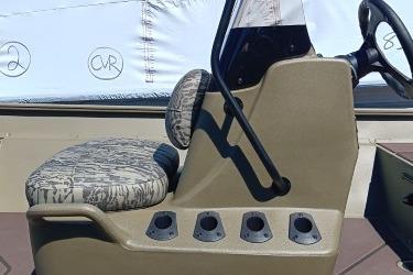 2026 Tracker Grizzly 2072 CC boat console with patterned seat and steering wheel.