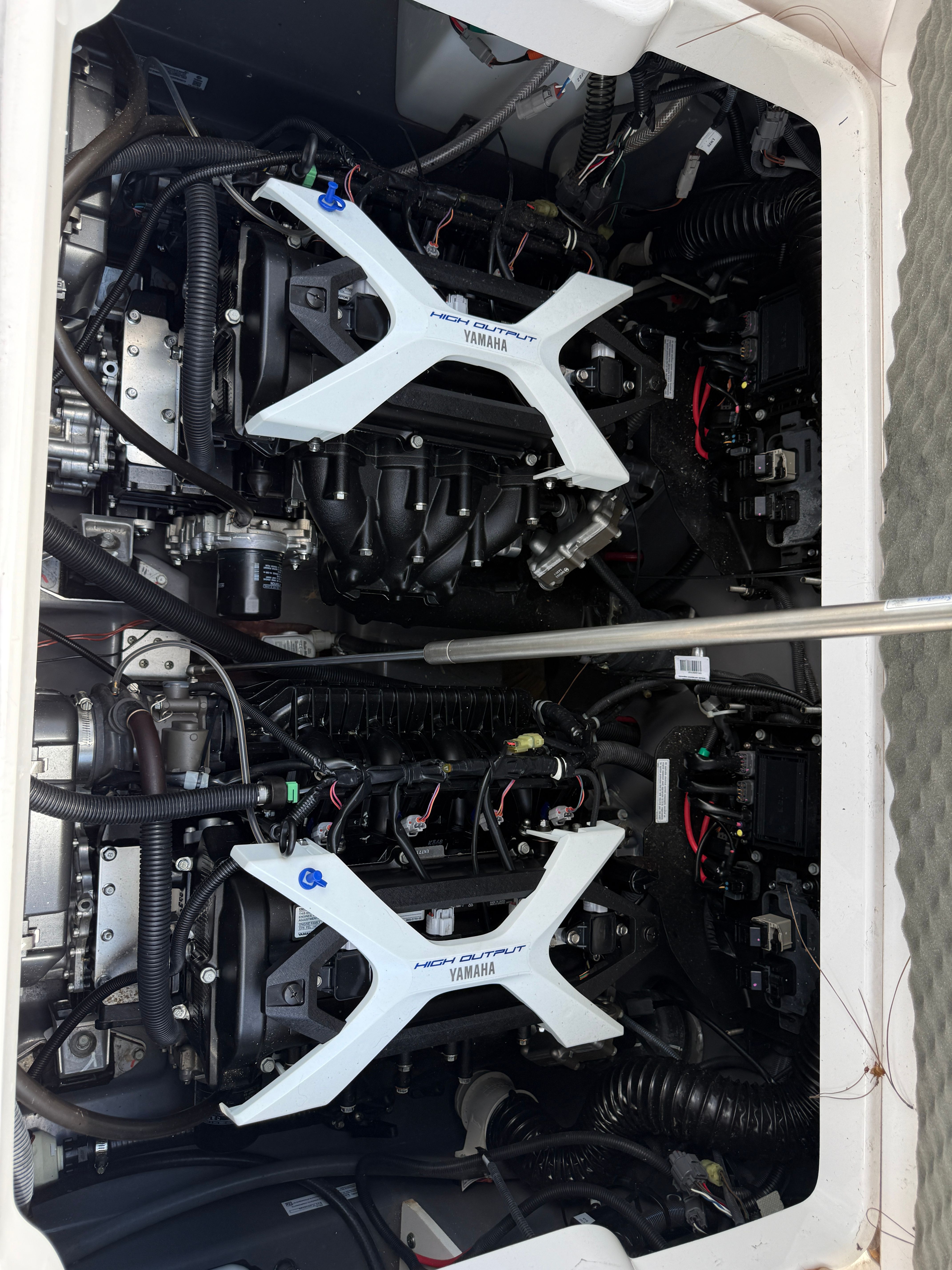 Engine compartment of the 2024 Yamaha 252 FSH Sport with dual engines.