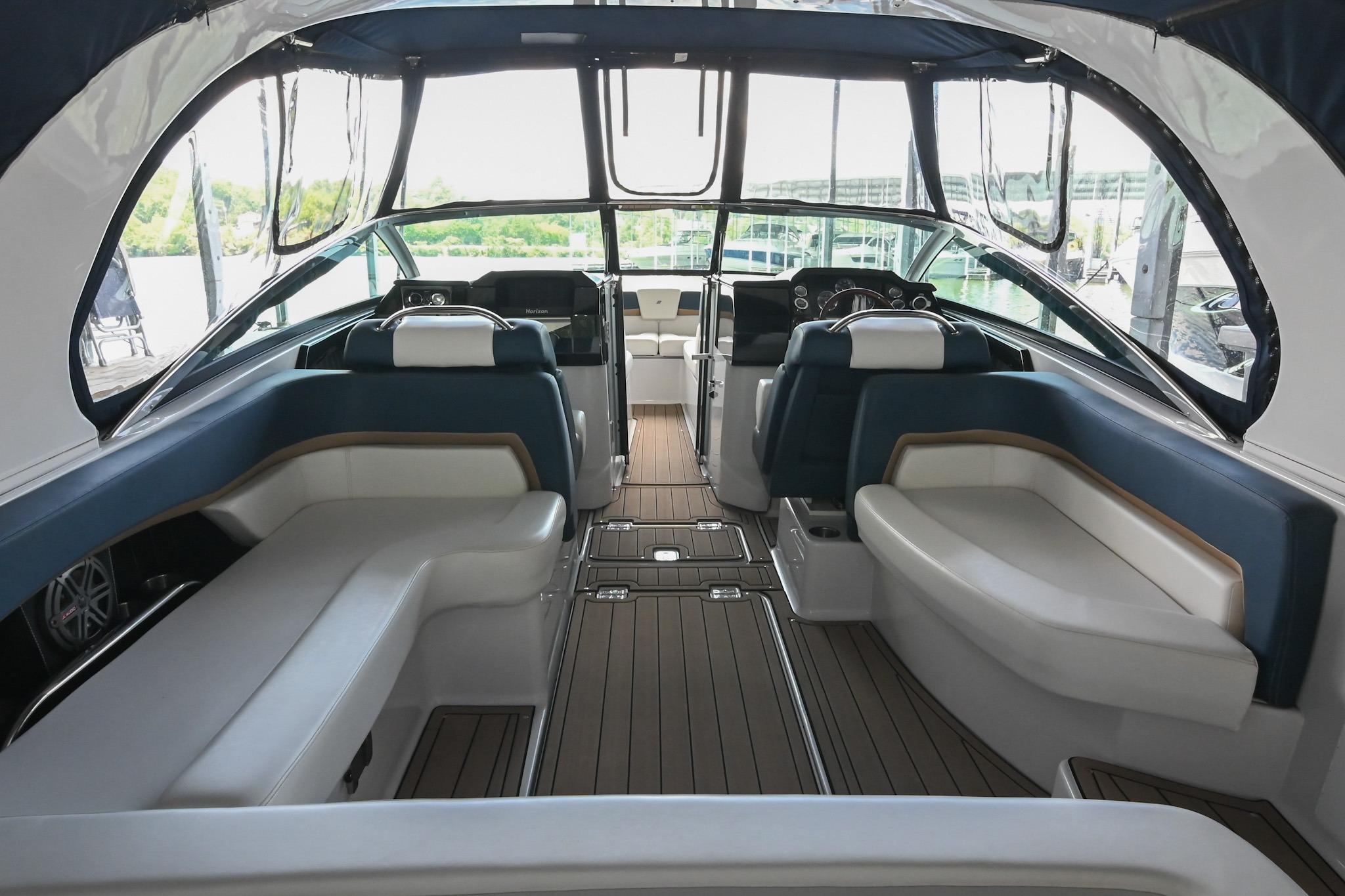 Interior of 2014 Four Winns H290 boat with luxurious seating and modern dashboard.