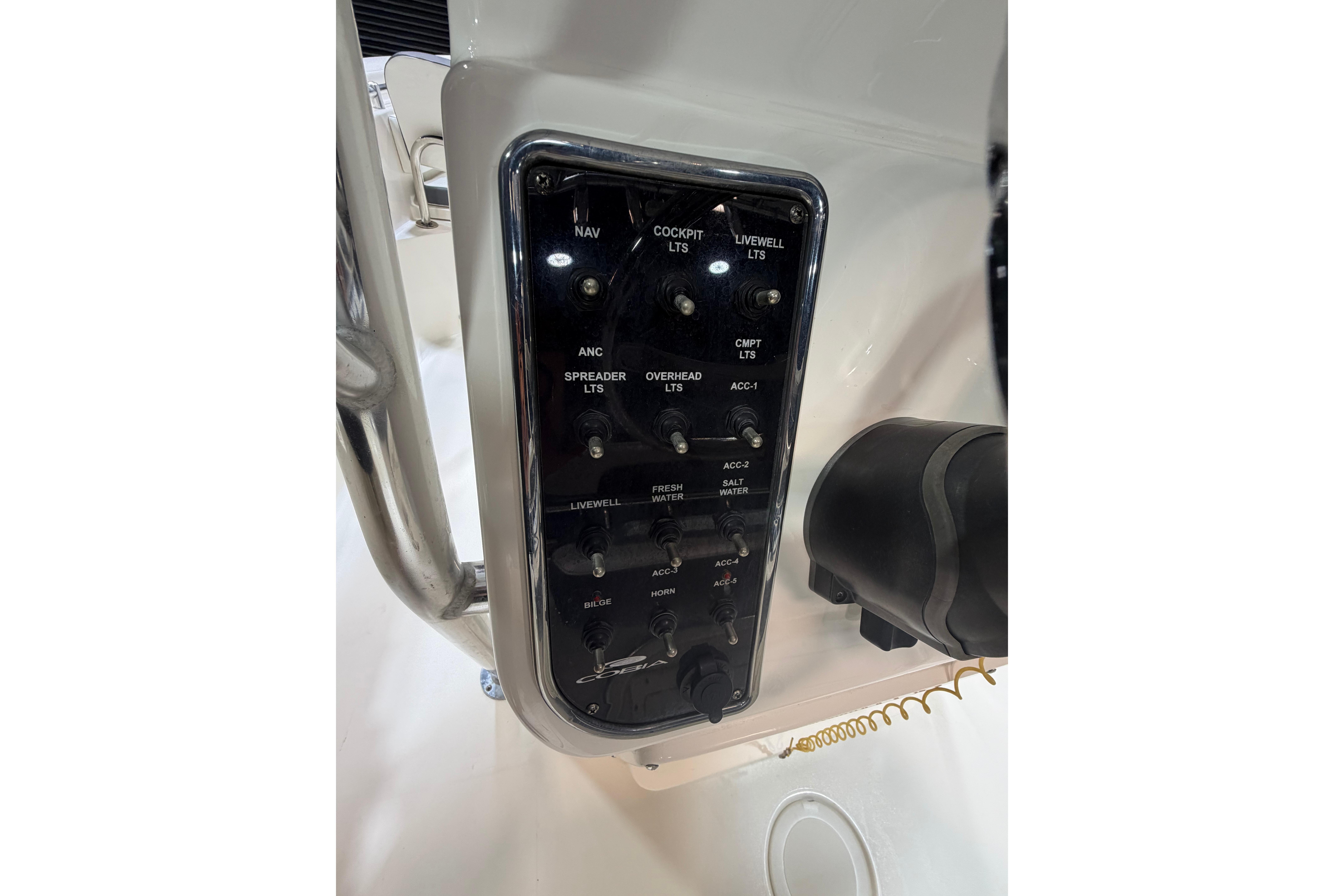 Control panel of 2023 Cobia 237 Center Console boat with labeled switches.