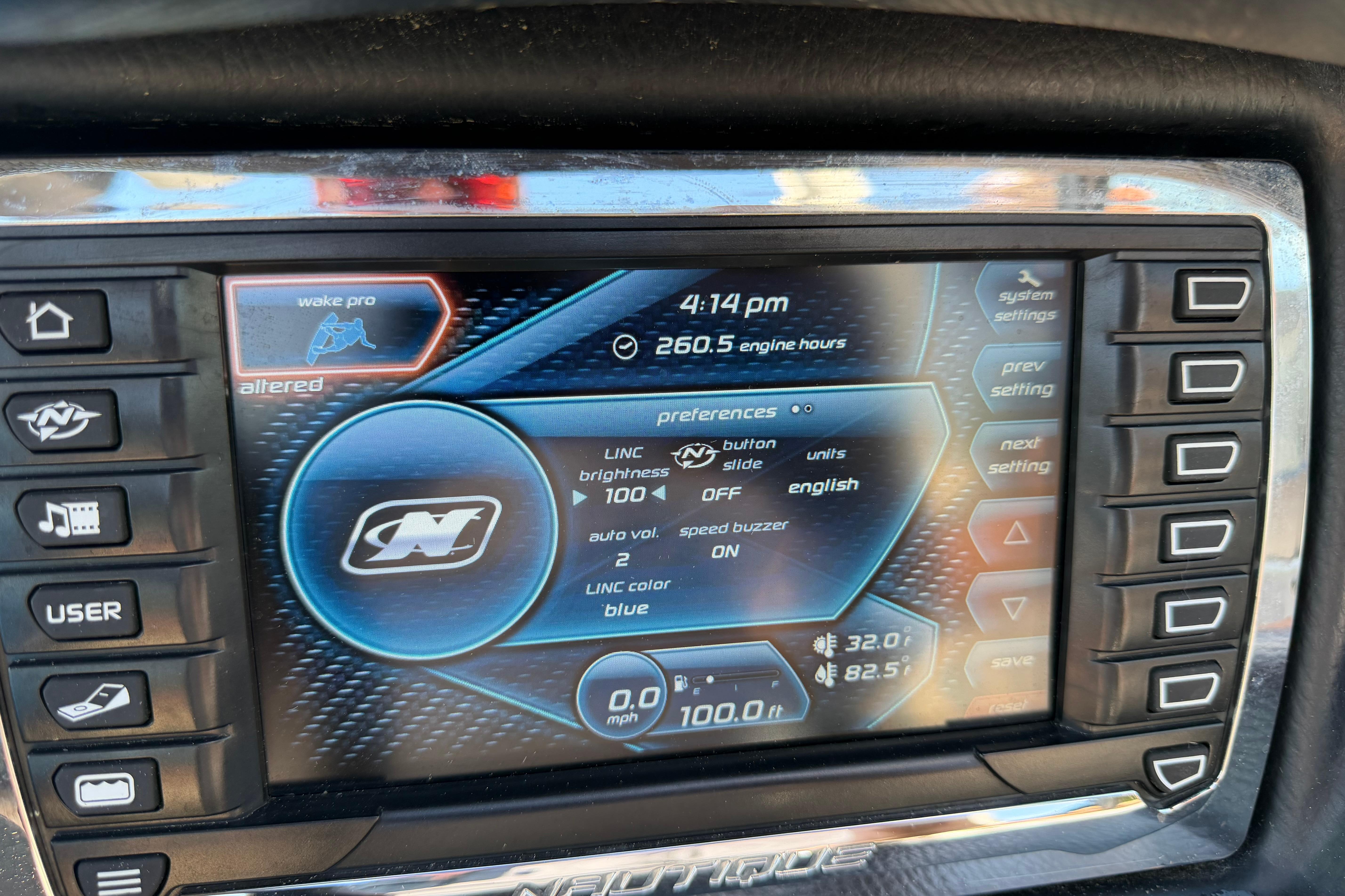 Touchscreen display of a 2015 Nautique Super Air Nautique 230 boat showing settings and engine hours.