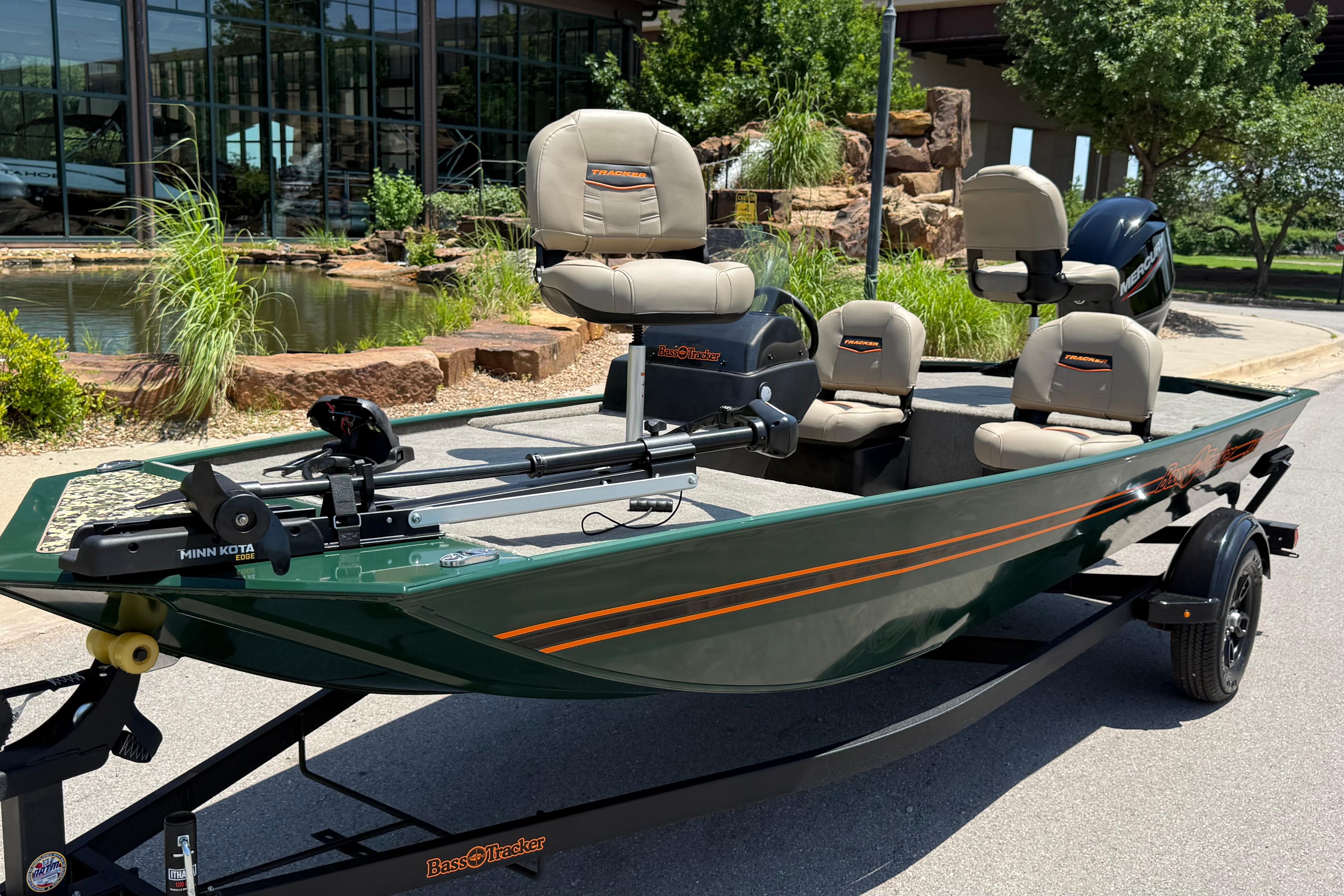2026 Tracker Bass Tracker Classic Limited boat on trailer, parked near a pond.