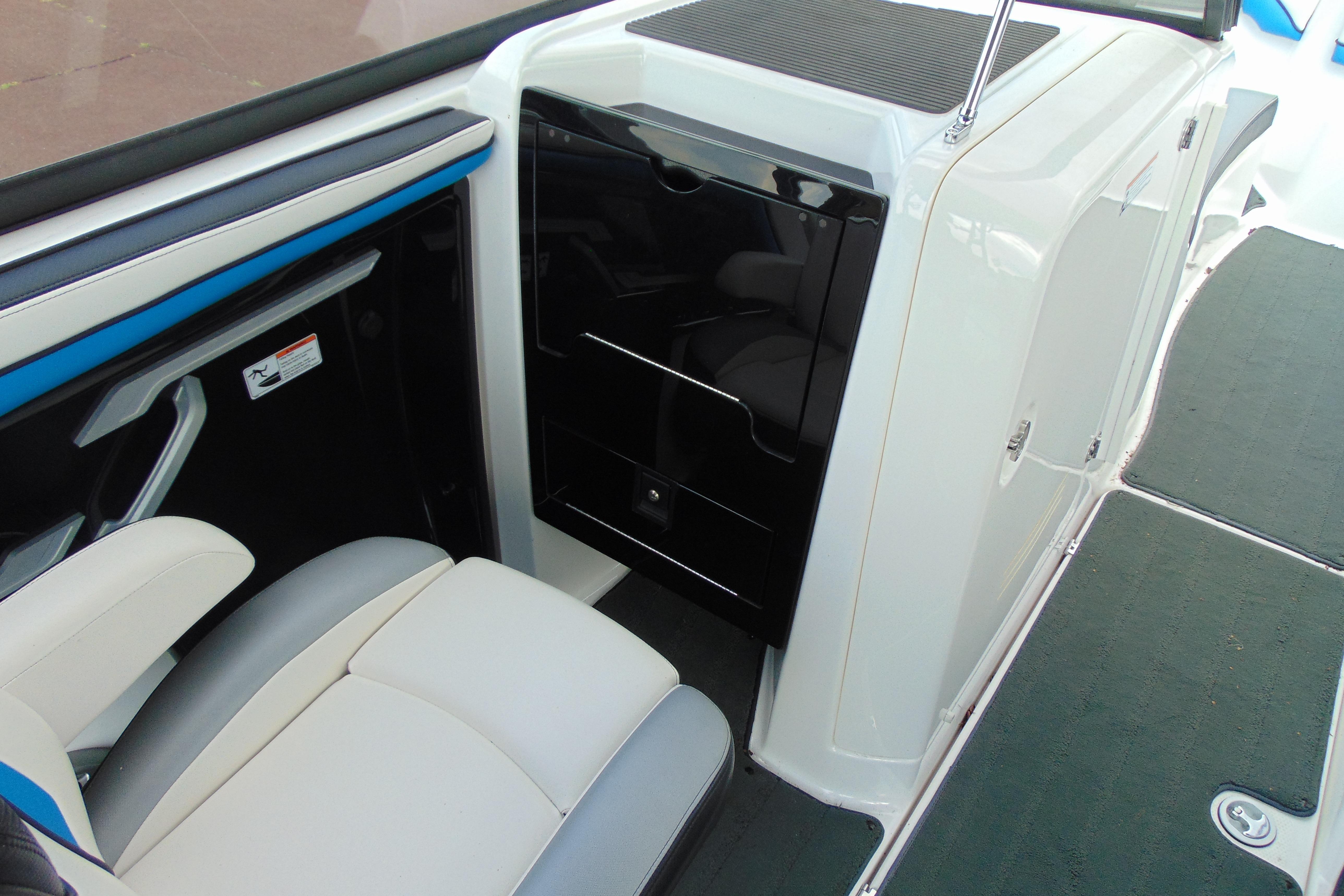 Interior view of 2016 Yamaha Boats 242X E-Series, featuring seating and storage area.