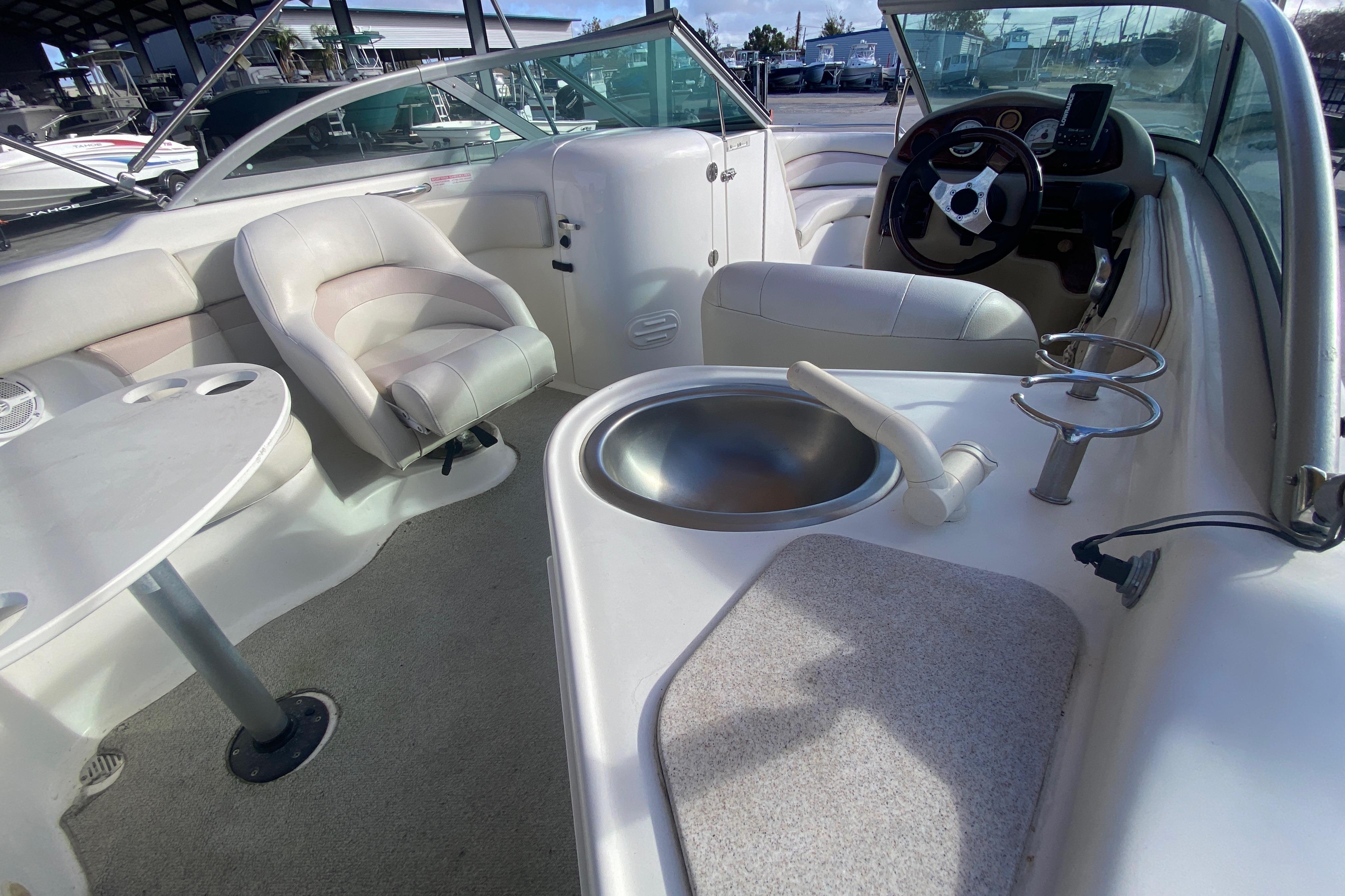 2007 NauticStar 230DC Sport Deck interior with seating, sink, and steering console.