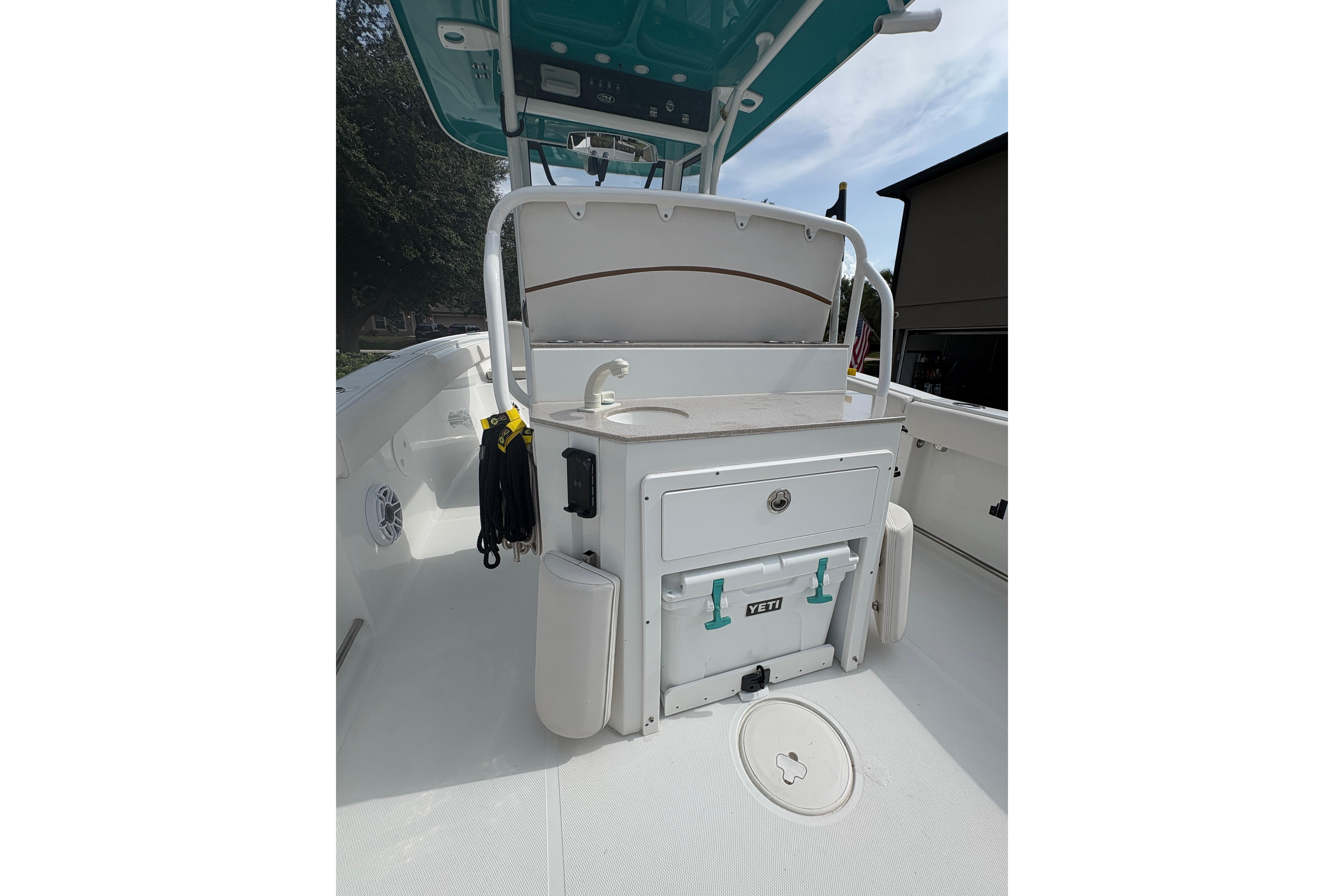2021 Sea Hunt Ultra 265 SE boat interior with storage and Yeti cooler.