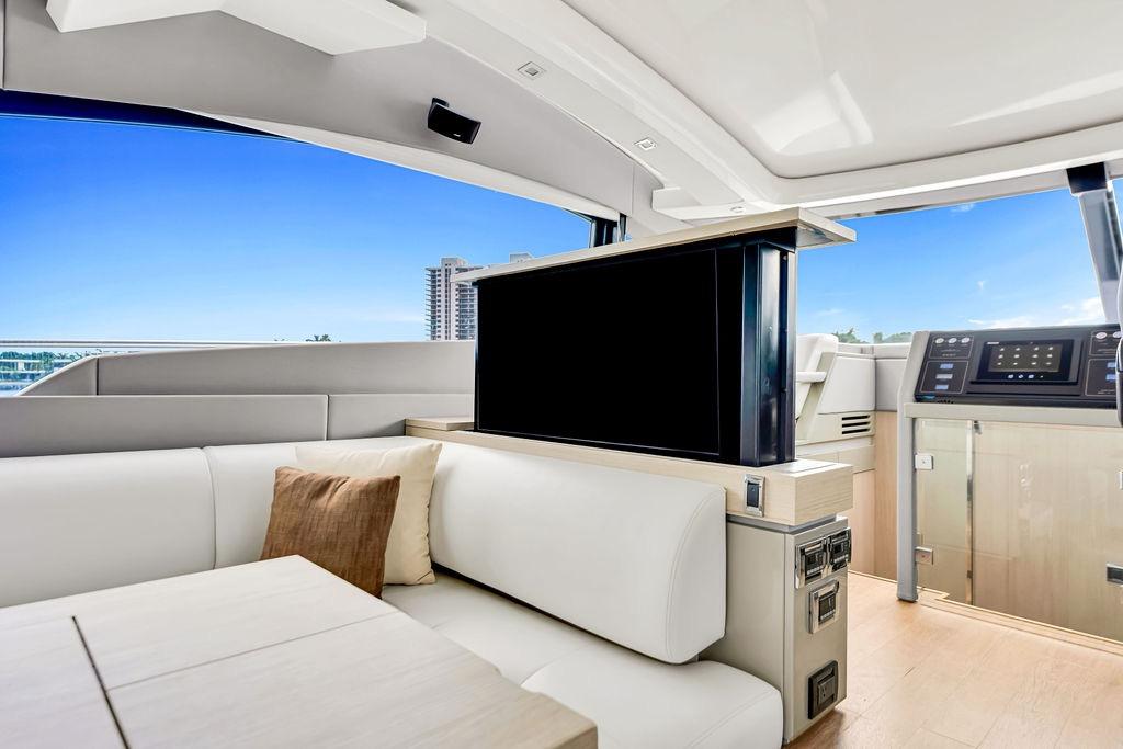 Luxurious interior of 2012 Fairline Targa 58 yacht with modern seating and retractable TV.