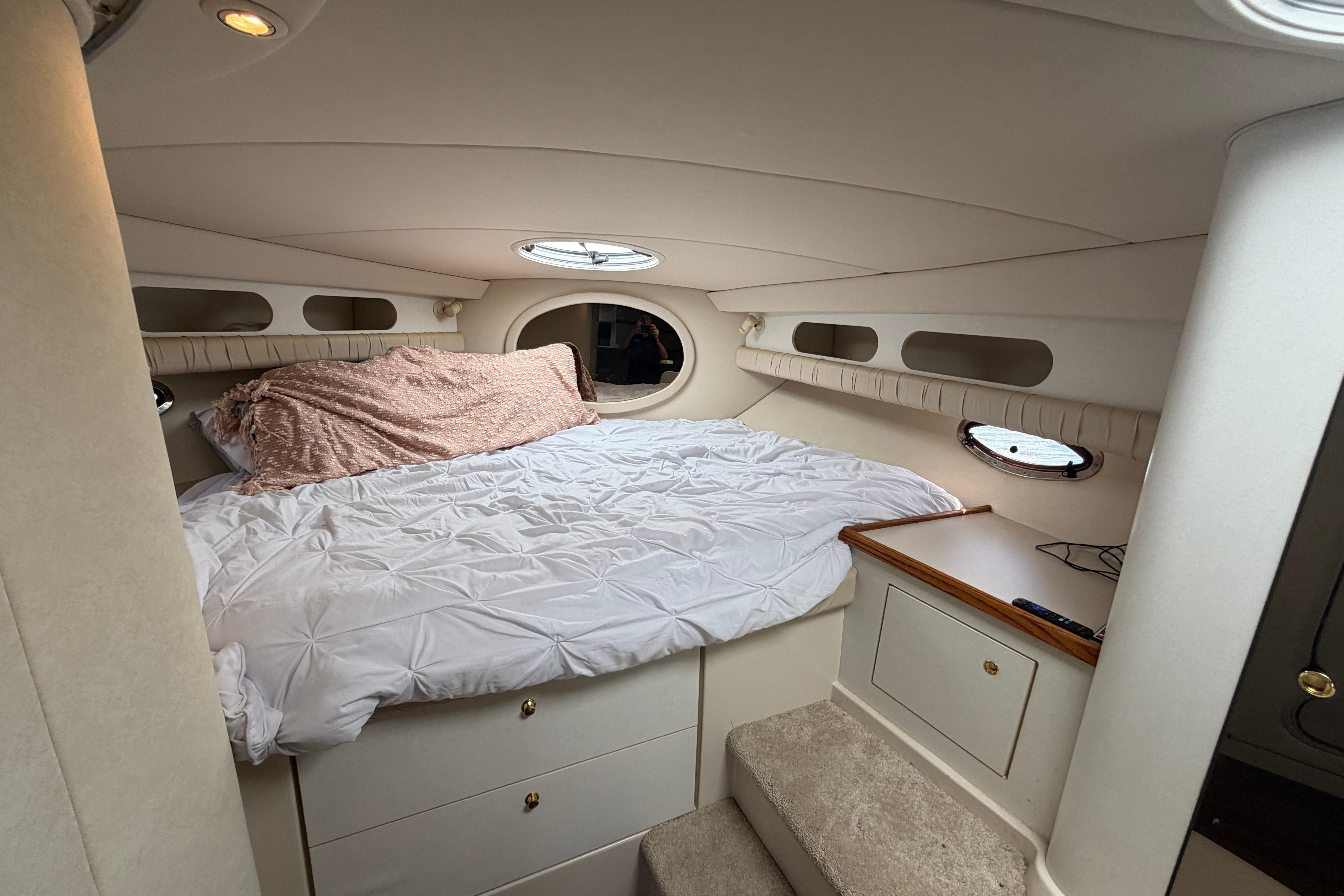 1997 Cruisers 3575 yacht interior cabin with cozy bed and storage drawers.
