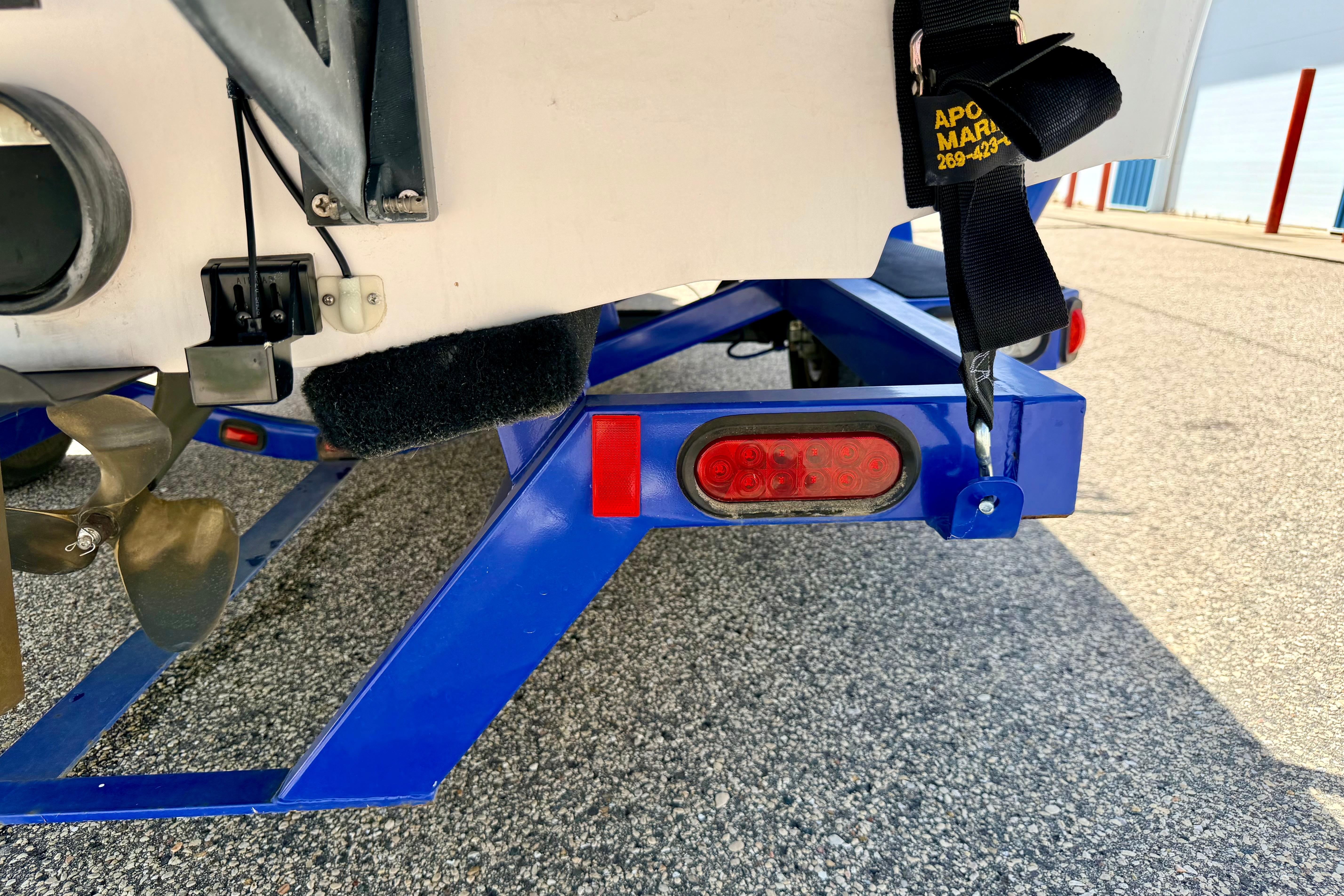 2008 Moomba Outback V boat trailer with blue frame and visible propeller.