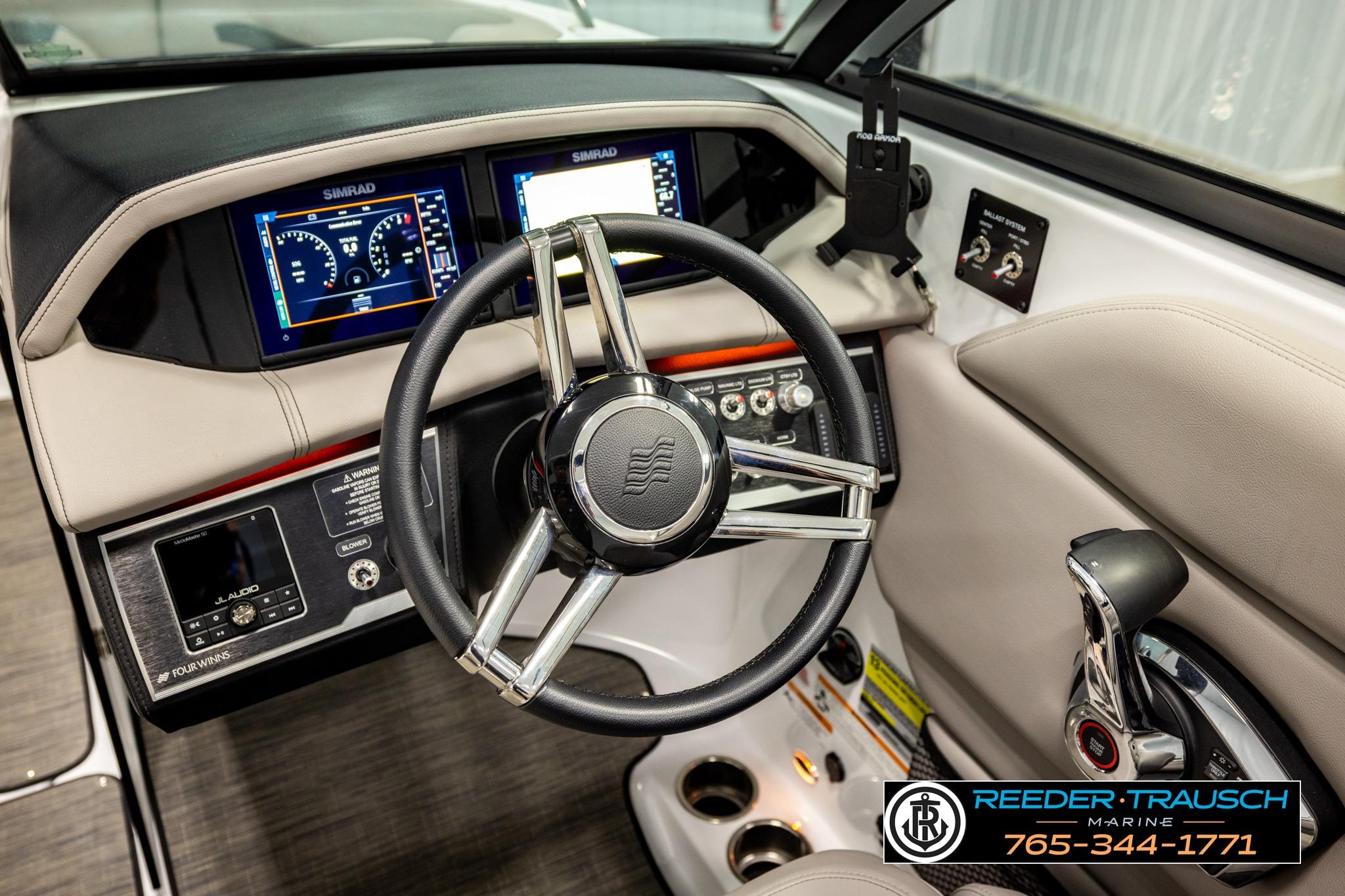 2024 FOURWINNS HD5 Surf boat dashboard with steering wheel and control panel.