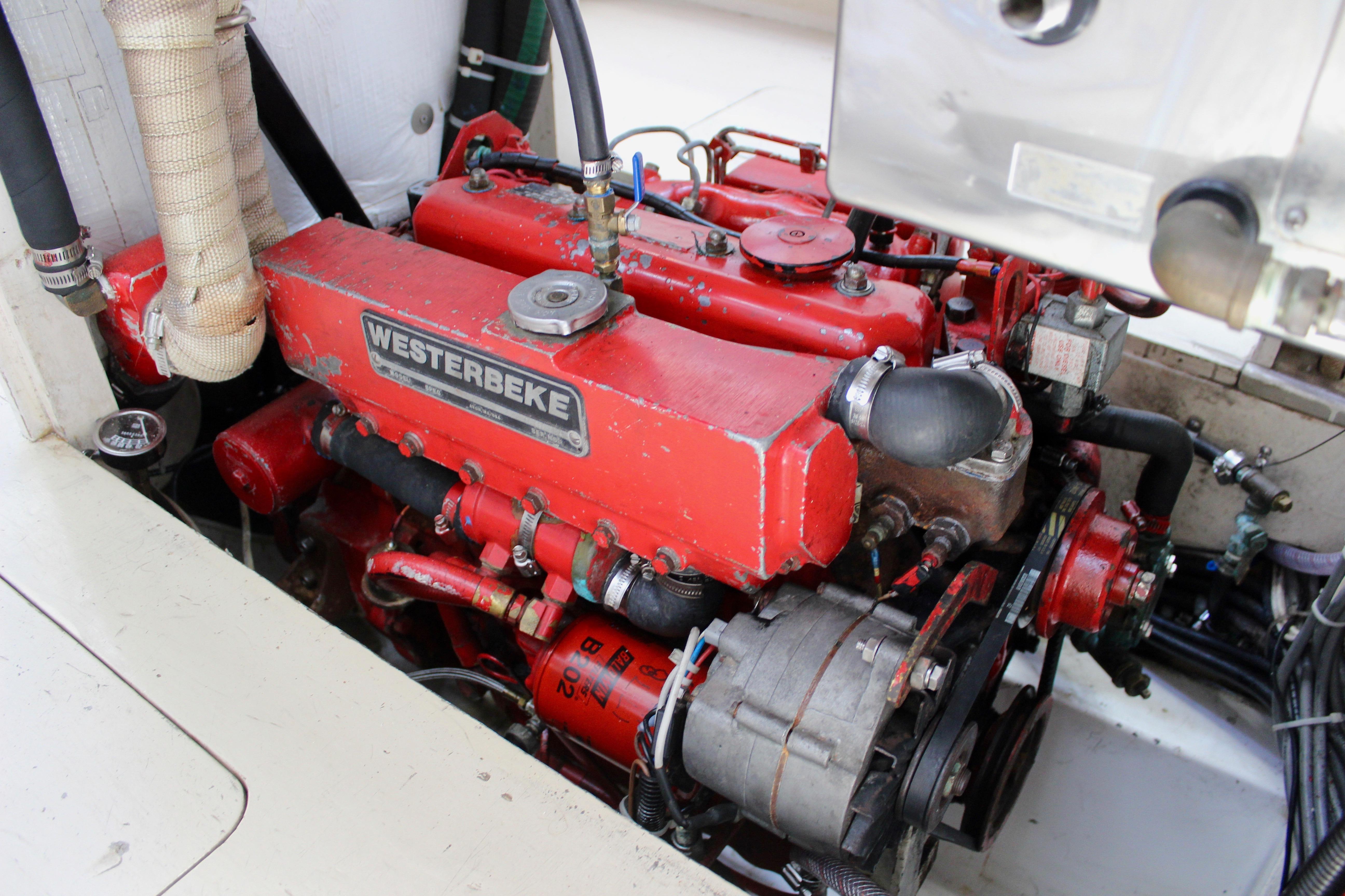 Red Westerbeke engine in a 1993 Freya 39 boat, showcasing detailed mechanical components.