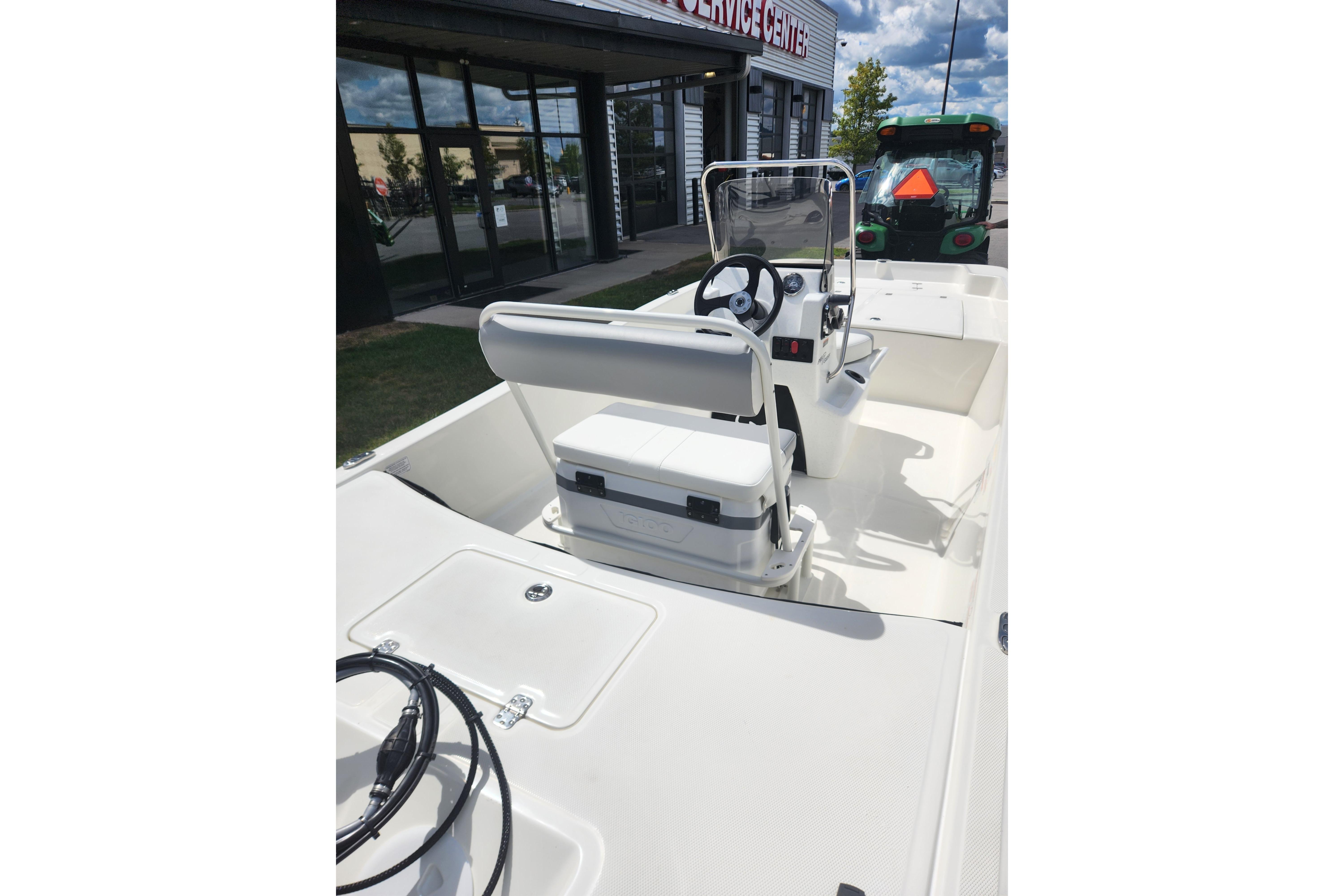 2026 Mako Pro Skiff 17 CC boat interior with console and seating, displayed outdoors.