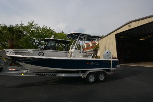 2021 Sea Pro 228 Bay boat on trailer near a storage facility.
