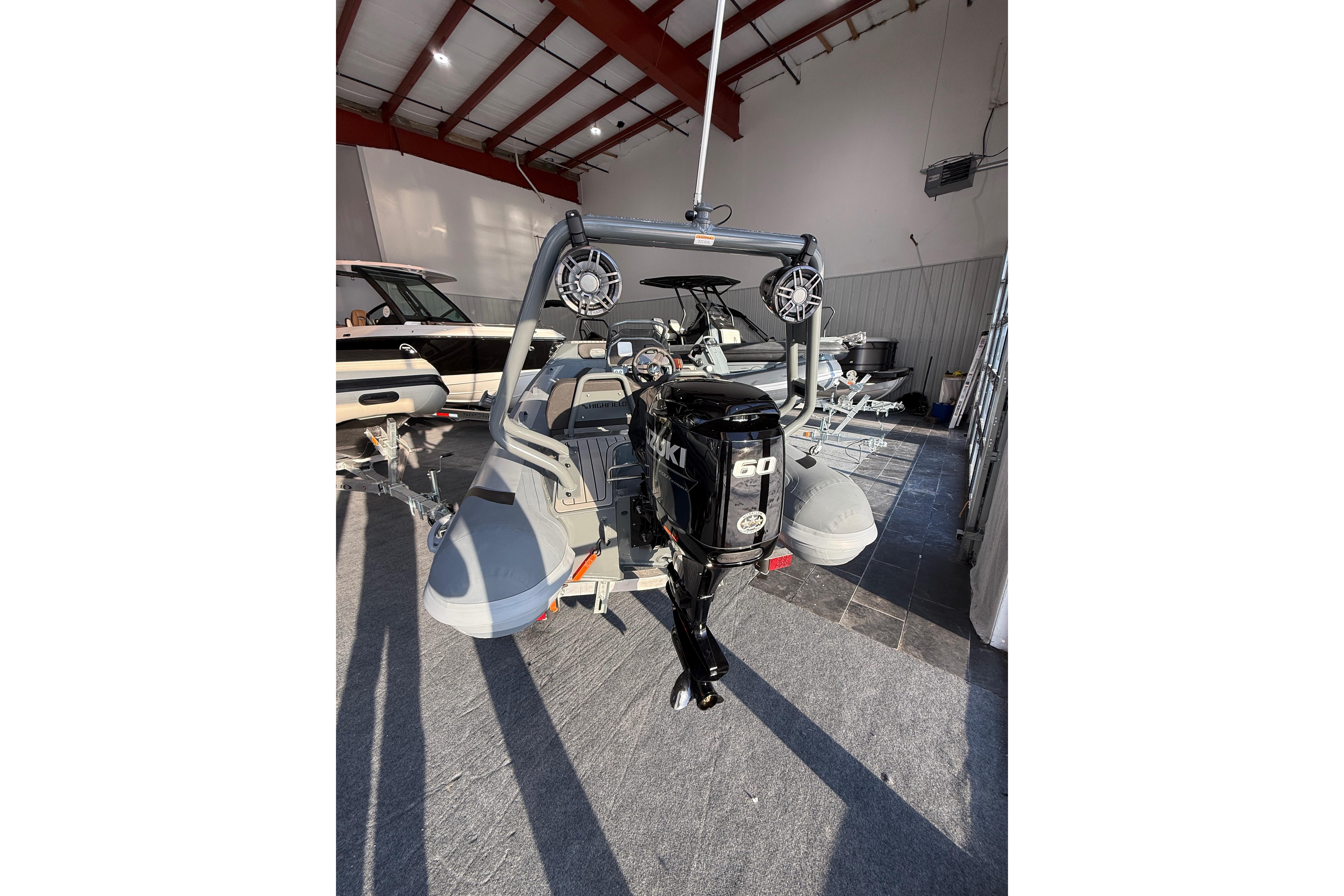2026 Highfield Sport 390 boat with 60 HP outboard motor in showroom.