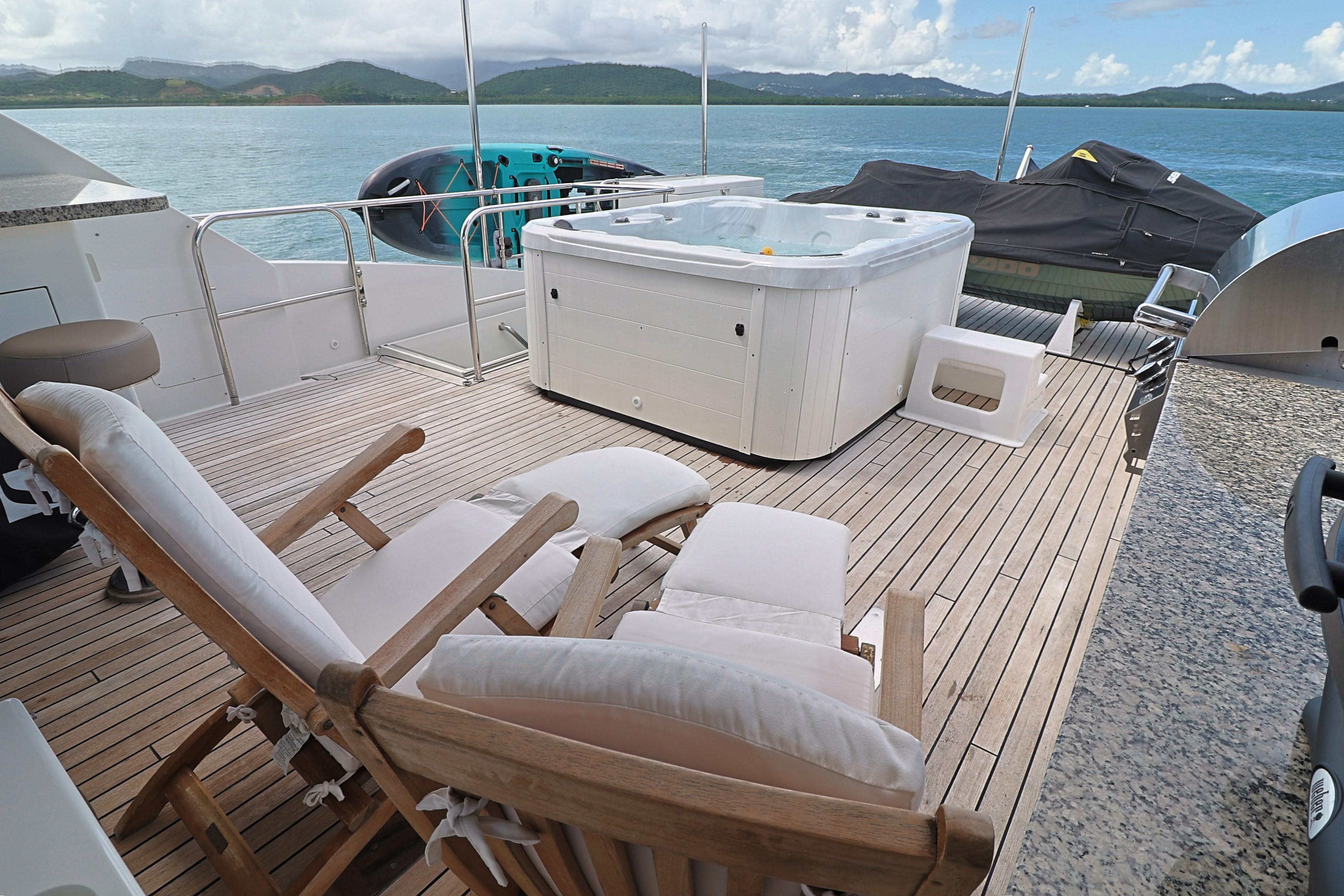 Luxury deck of 2013 Cheoy Lee Bravo yacht with hot tub and lounge chairs.