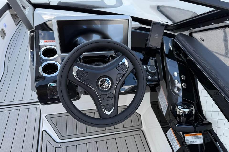 2026 Yamaha Boats 275SD dashboard with steering wheel and touchscreen display.