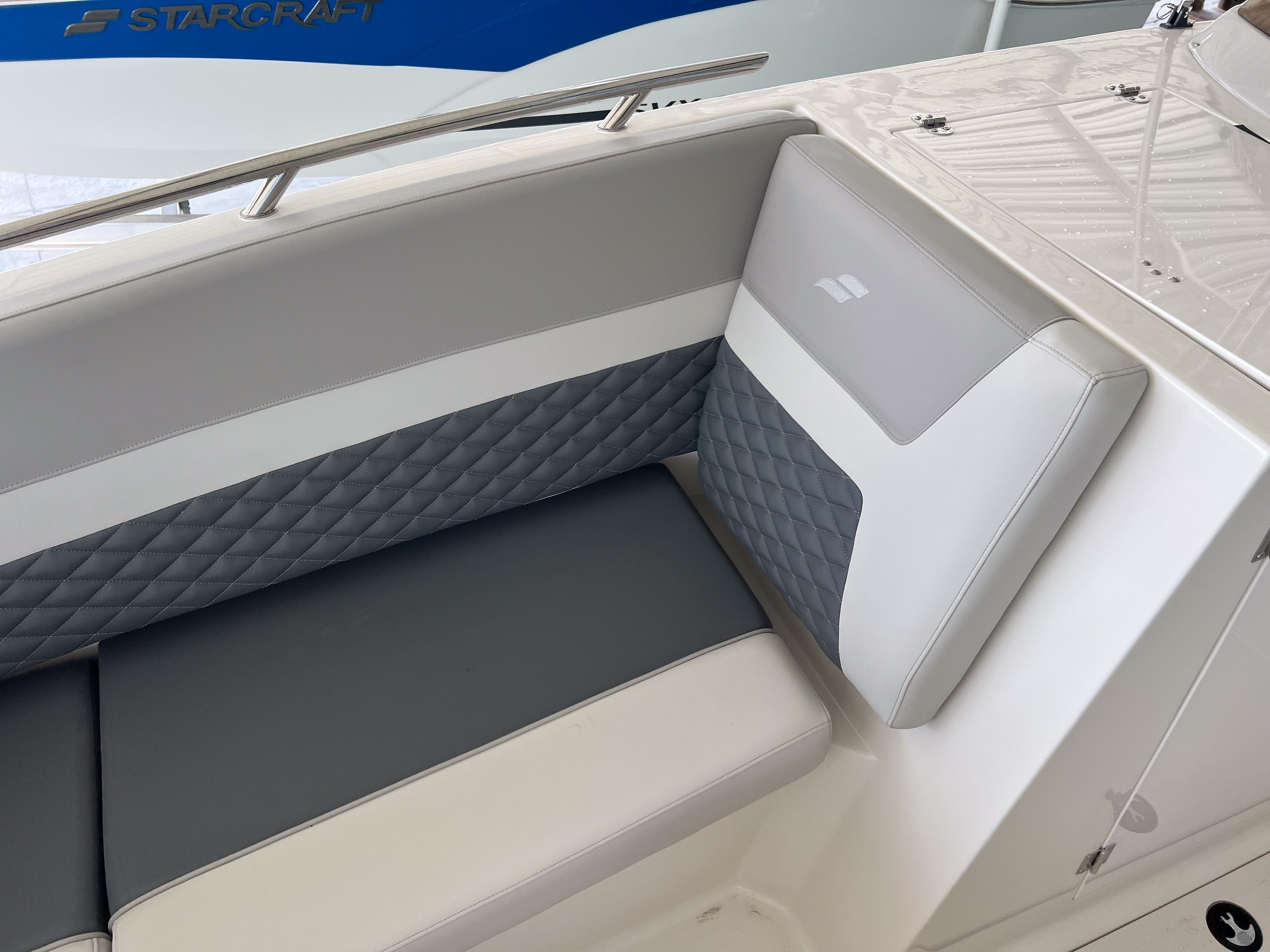 2026 Starcraft SVX 231 OB boat interior with gray and white cushioned seating.