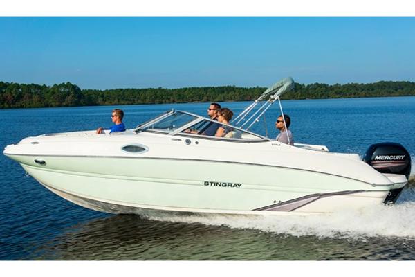 Manufacturer Provided Image: 2018 Stingray 214 LR boat cruising on a lake with passengers.