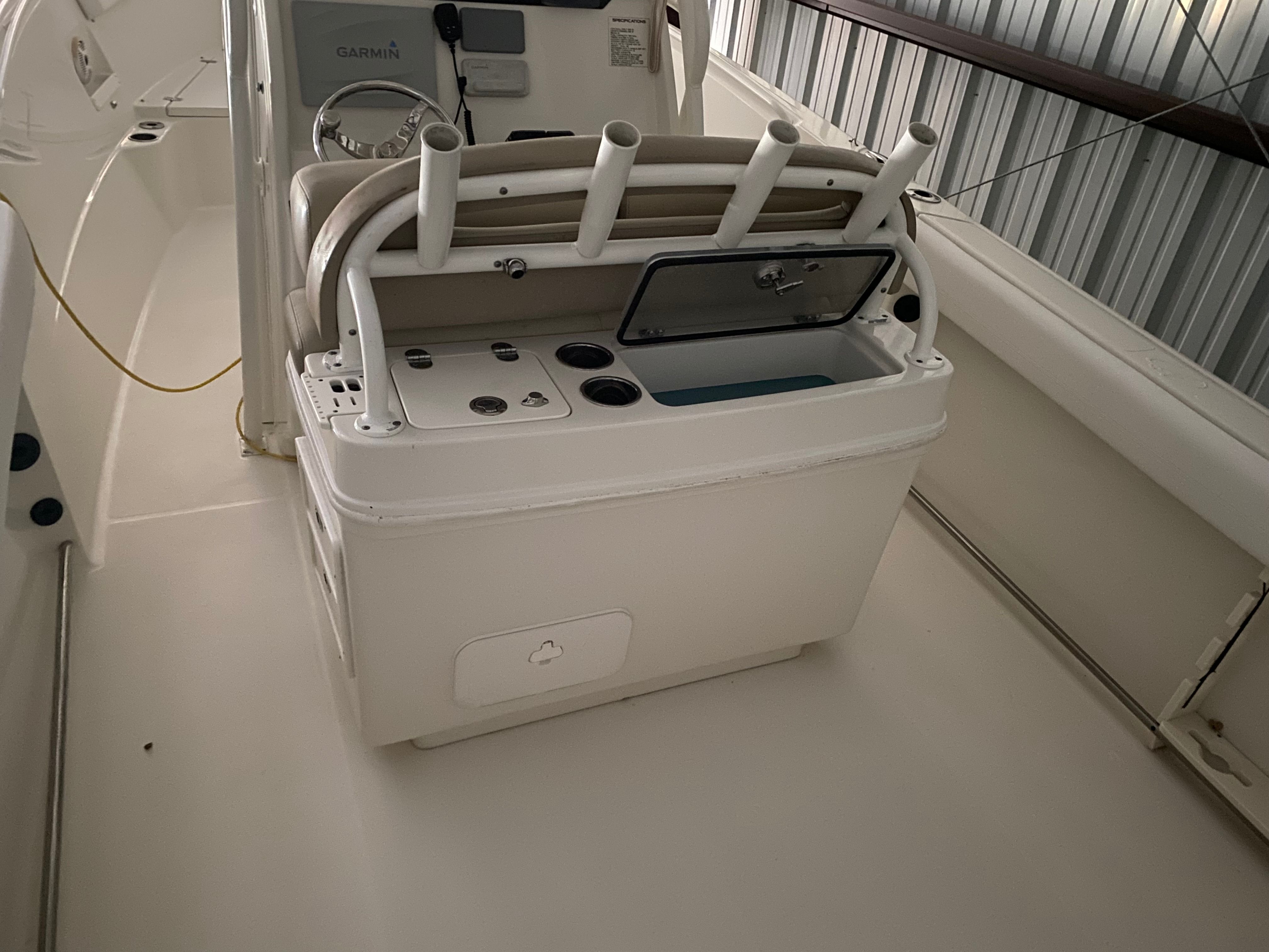 The interior of a Sailfish 270 CC boat with a helm console and fishing rod holders.