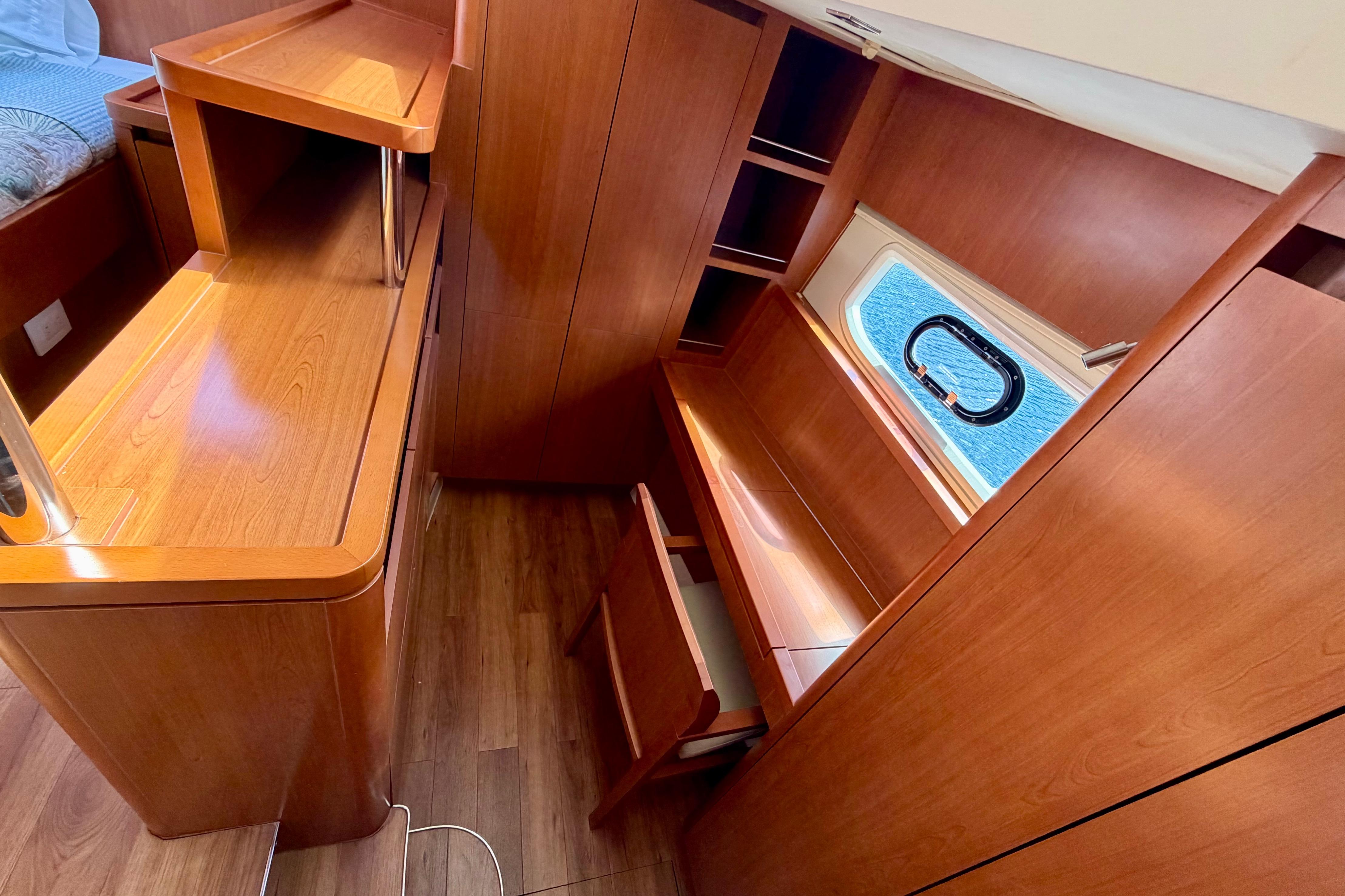 Interior of 2017 Aquila 44 Yacht with wooden cabinetry and window view.