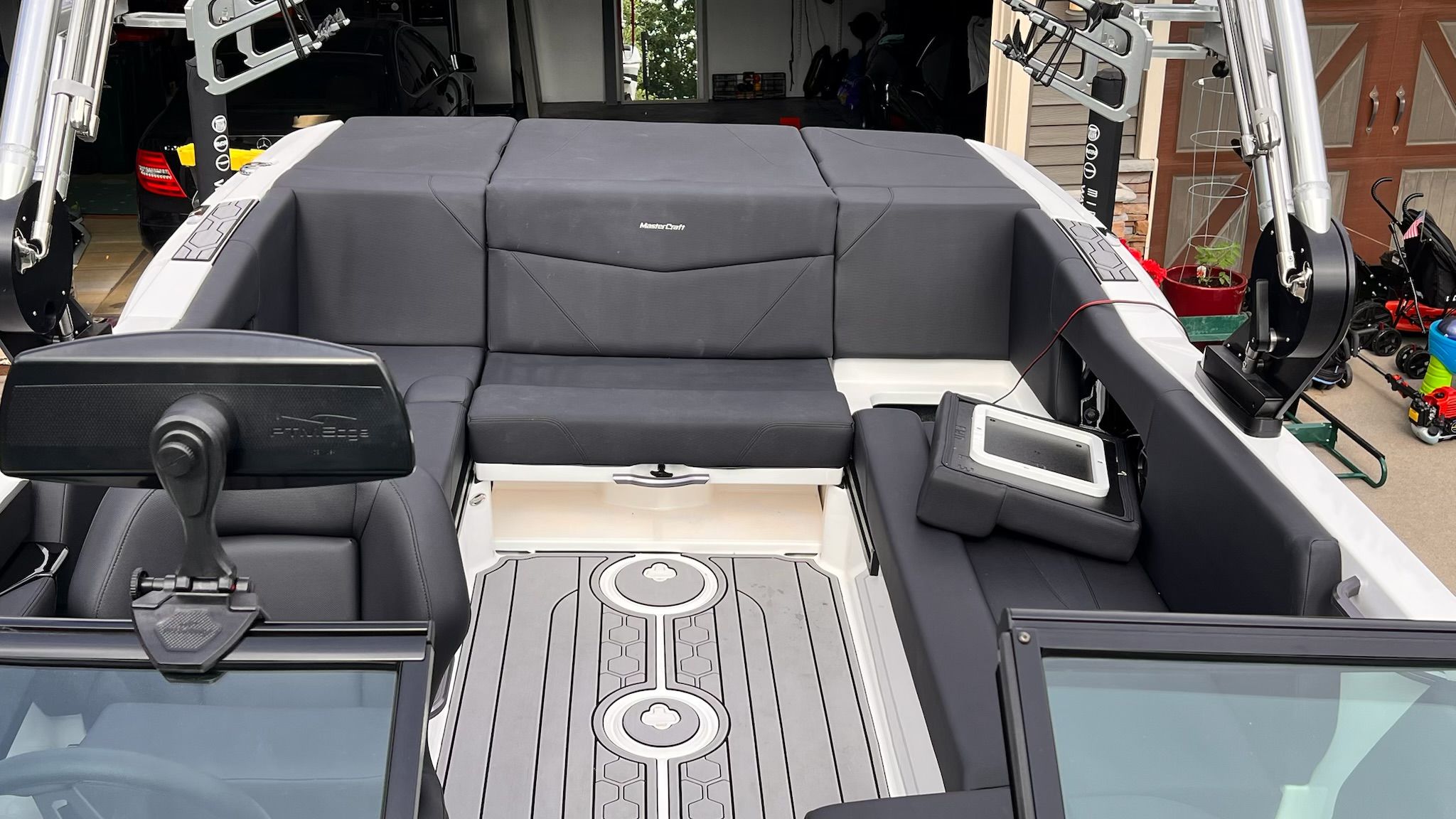 The image shows the cockpit of a 2020 MasterCraft NXT22 with gray upholstery and modern fixtures.