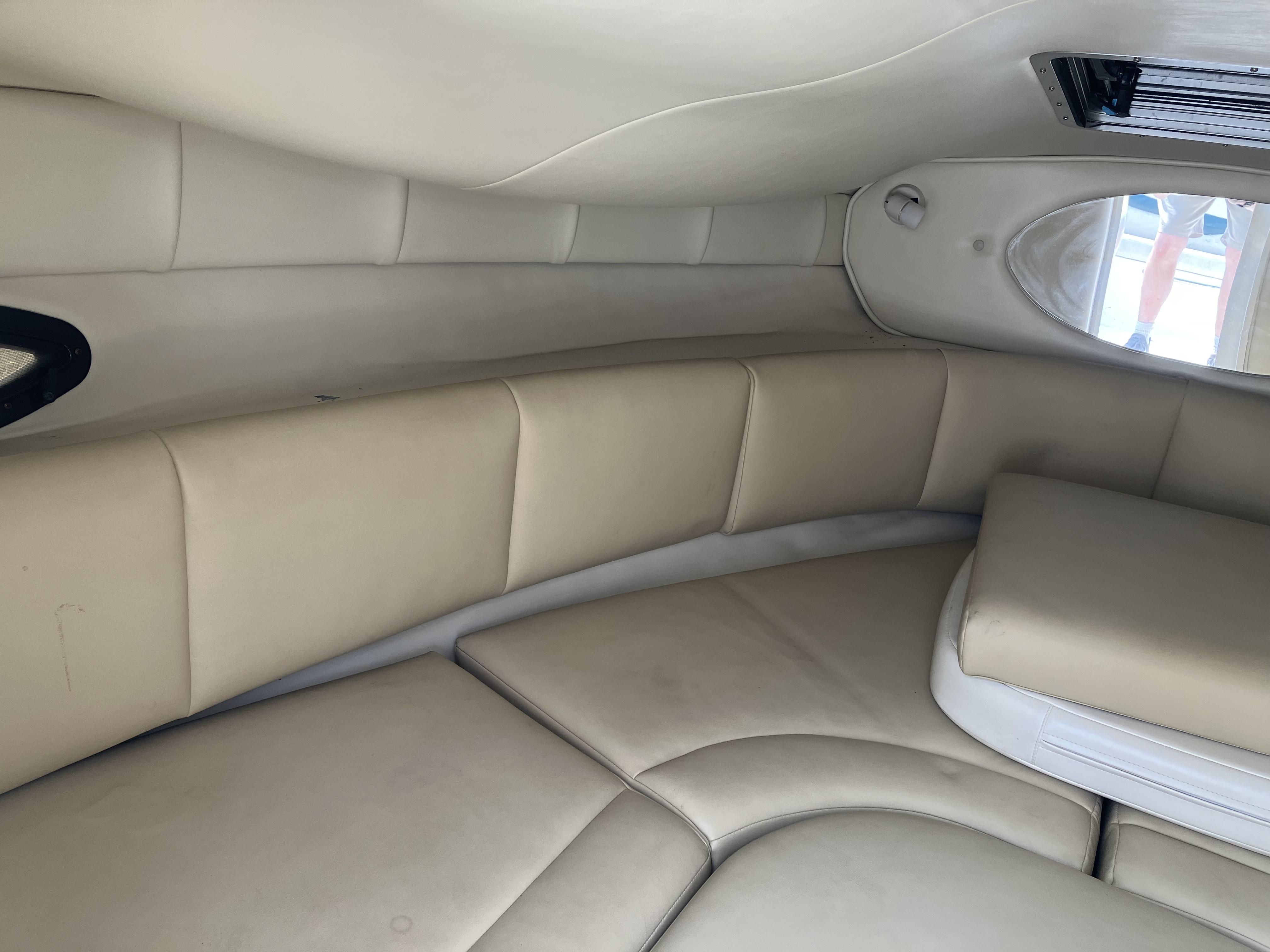 Interior of a 2001 Chaparral 235 SSi with beige upholstery and a window.