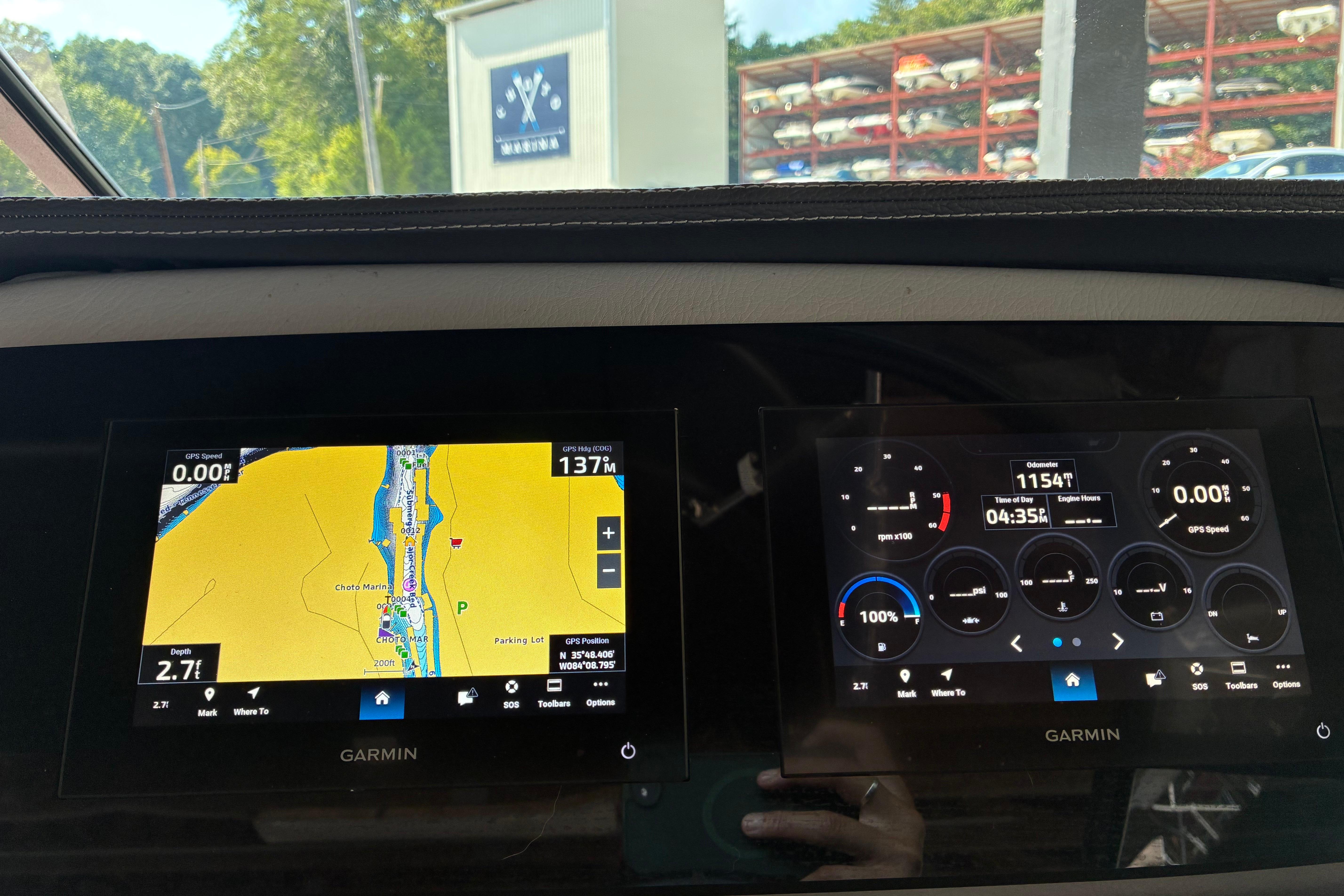 Dashboard of a 2025 Regal LS2 boat with Garmin navigation displays.