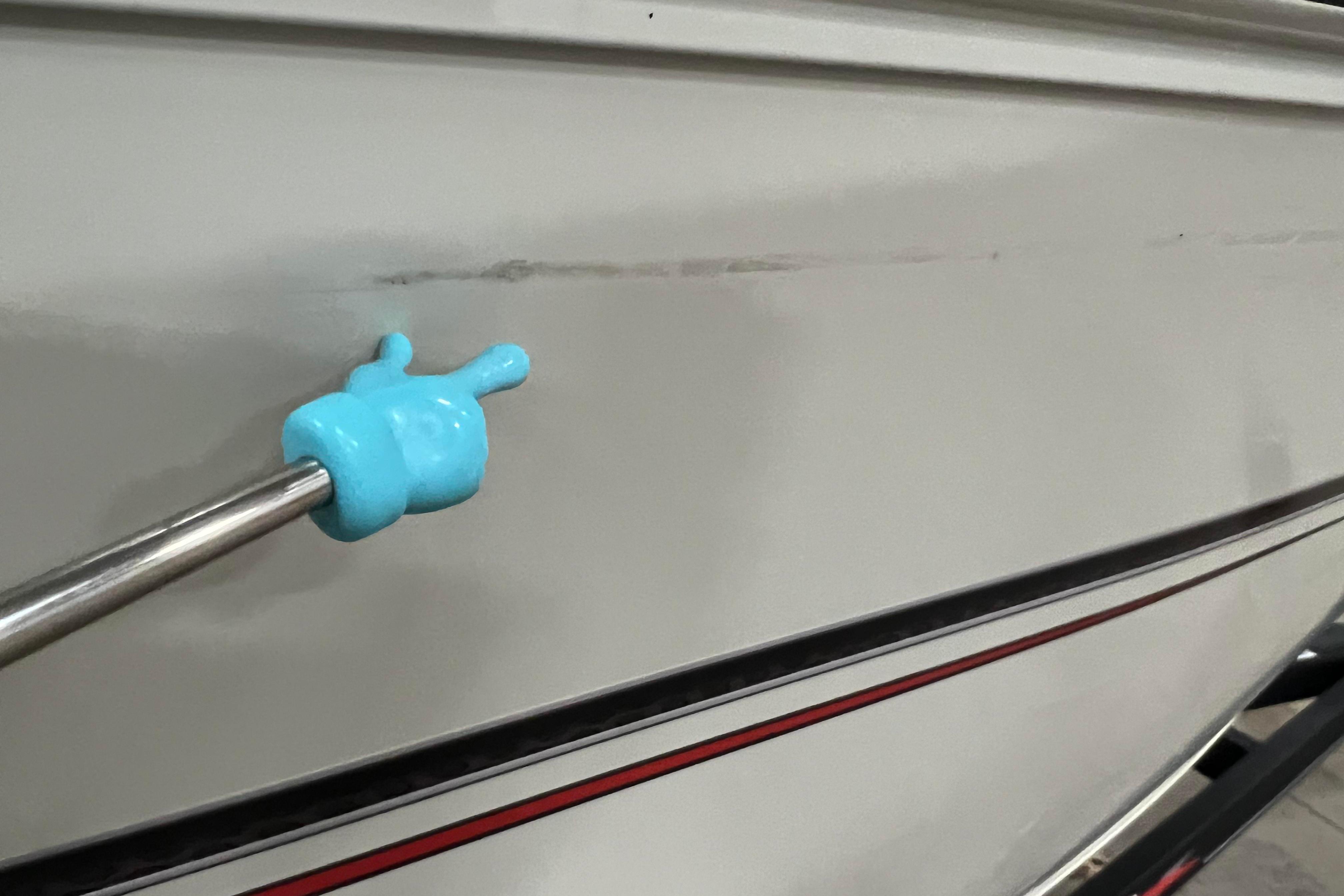 2022 Tracker Pro Guide V-16 WT boat with blue tool on hull.