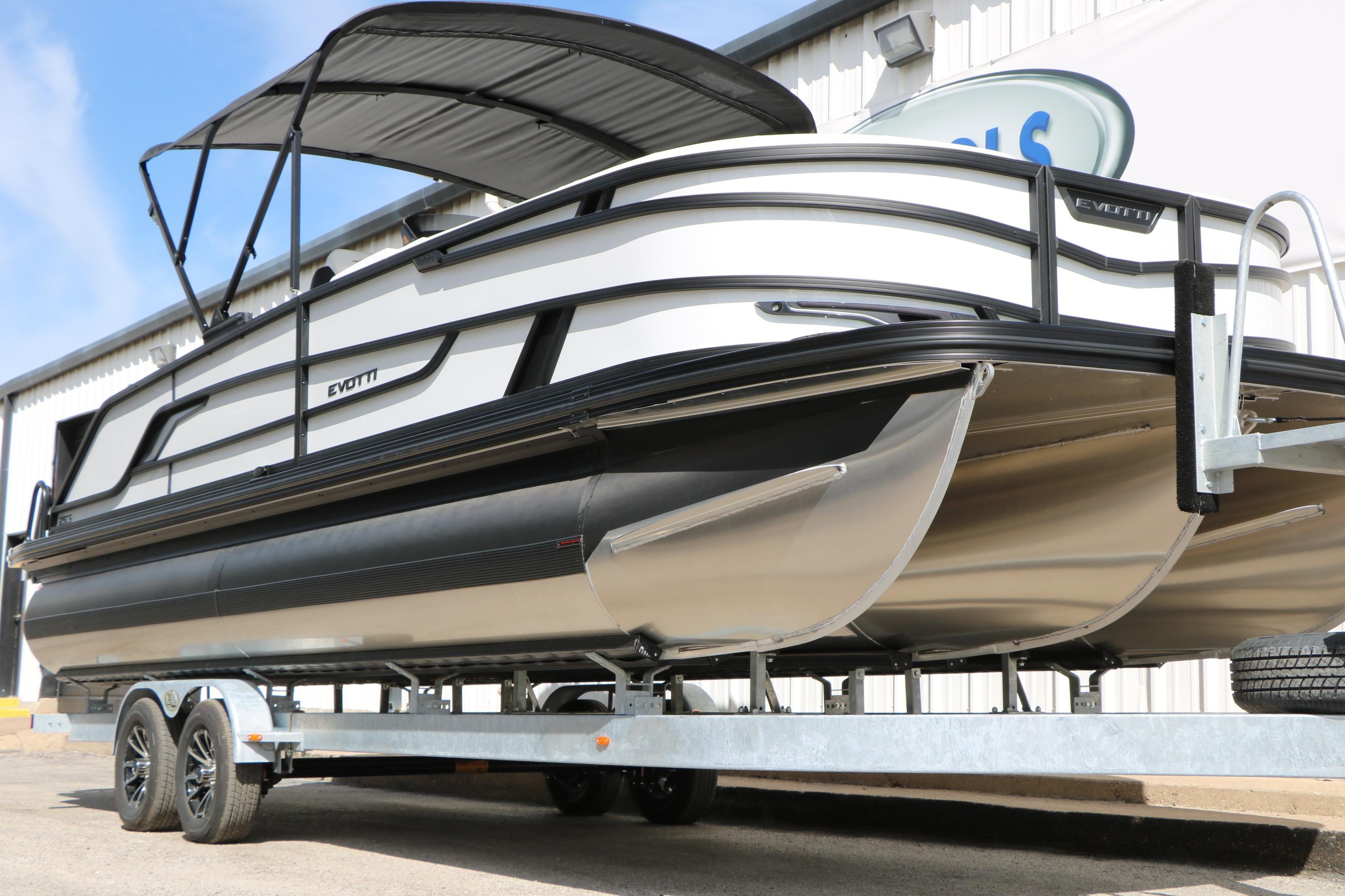 2026 Evotti 725 CS Tri-Toon boat on trailer, featuring sleek design and modern canopy.