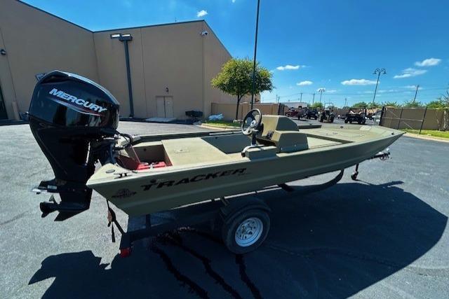 2026 Tracker Grizzly 1648 SC boat with Mercury engine on trailer, parked outdoors.