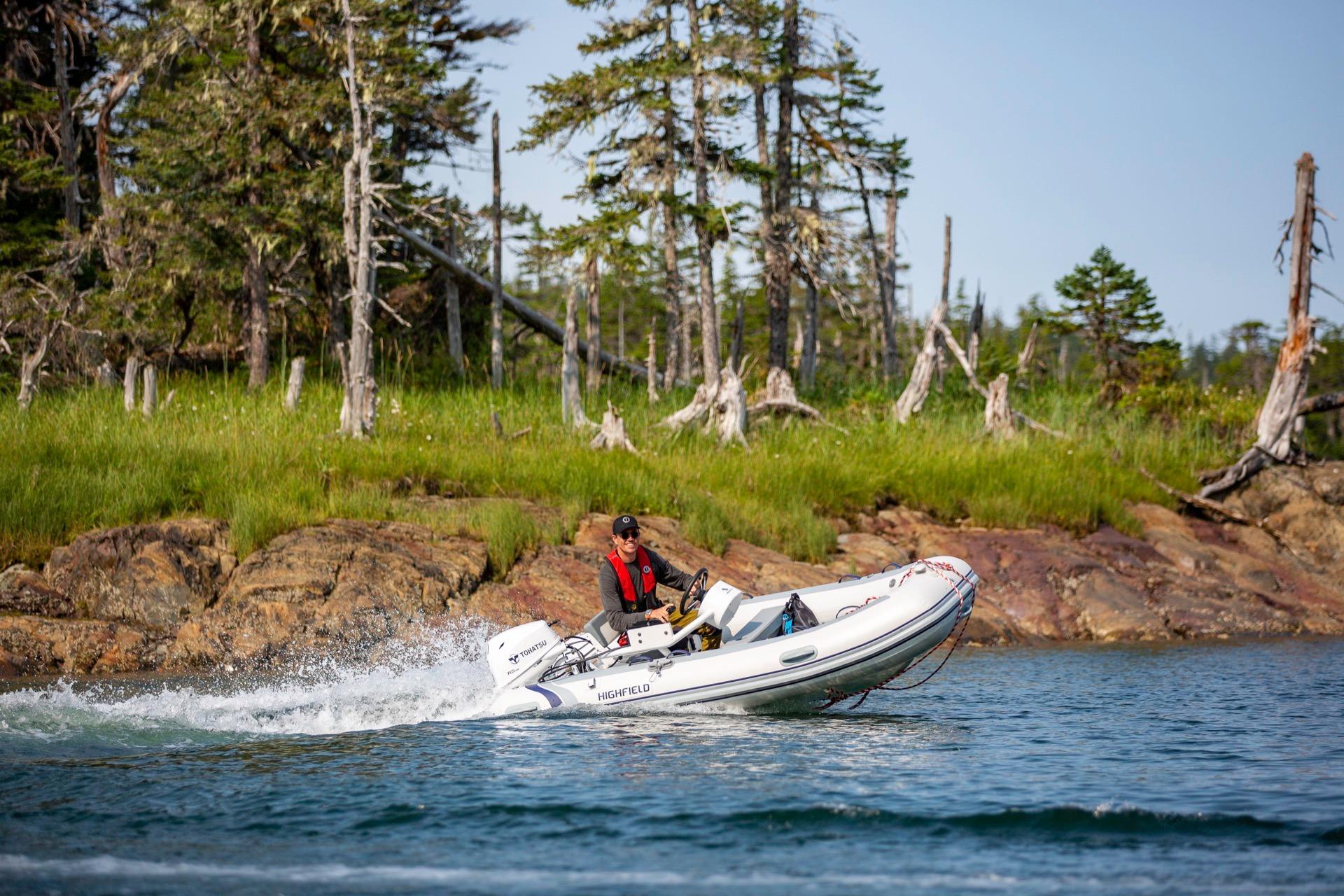Highfield Classic 360 boat 2026 on water near wooded shoreline.