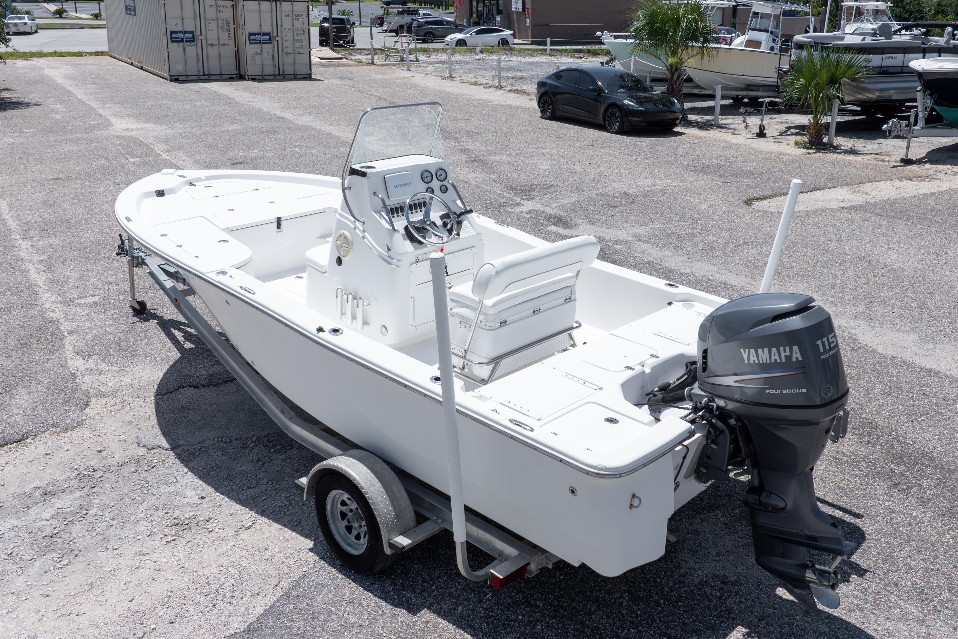 2011 Sea Fox 200XT boat with Yamaha 115 engine on trailer in parking lot.
