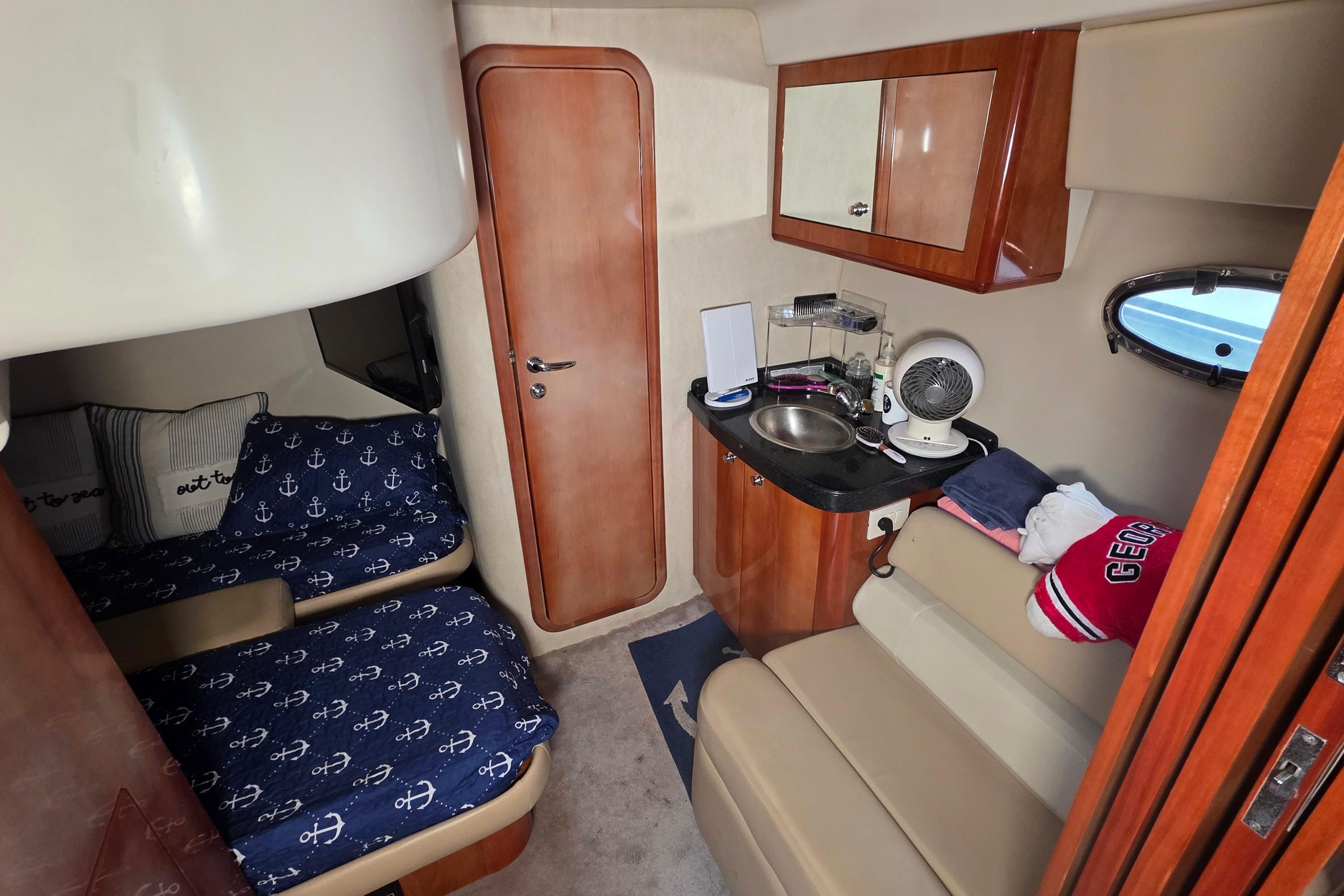 Interior of 2002 Regal Commodore 4260 yacht with cozy cabin and kitchenette.