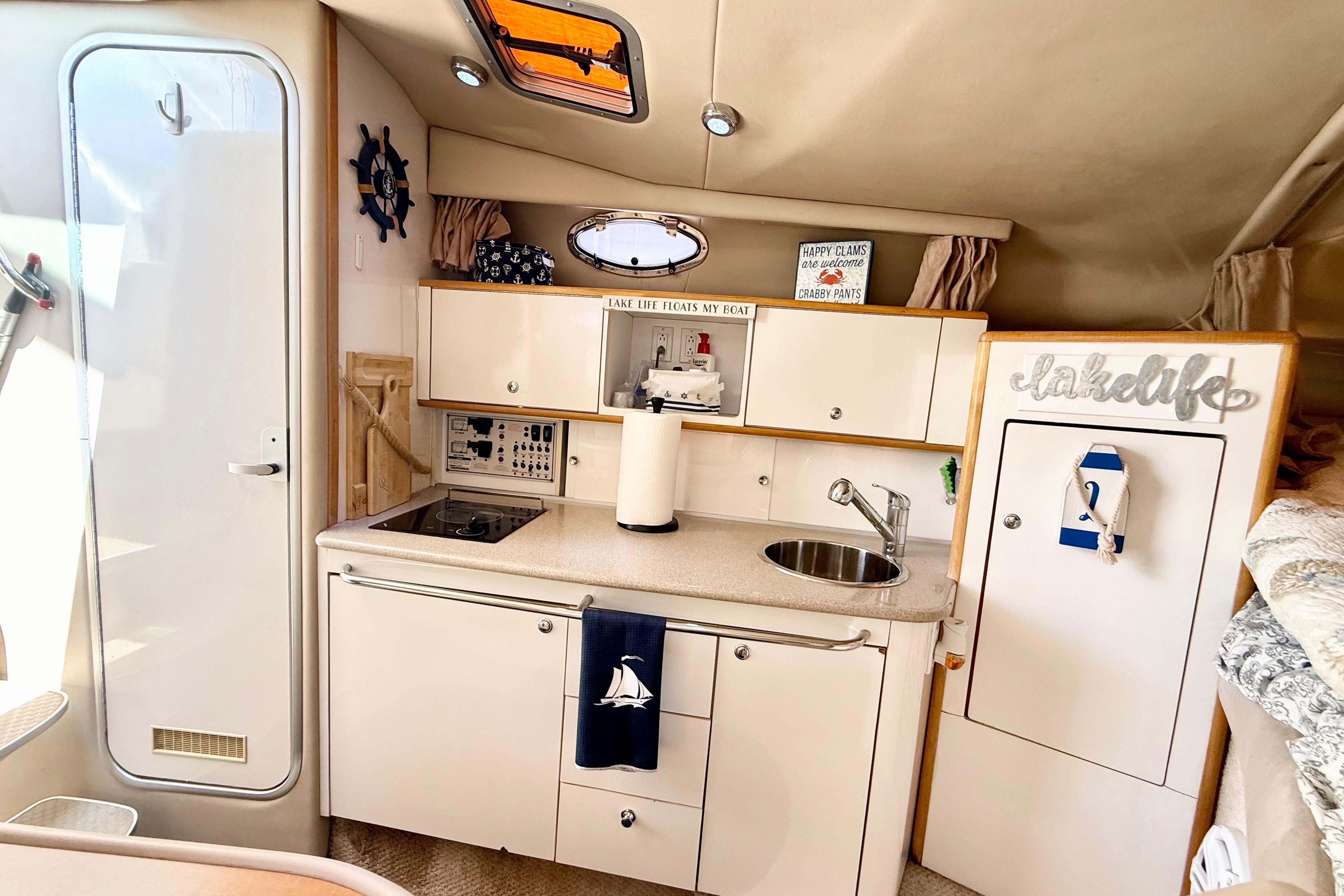 1999 Chaparral Signature 300 boat interior with kitchenette, sink, and nautical decor.