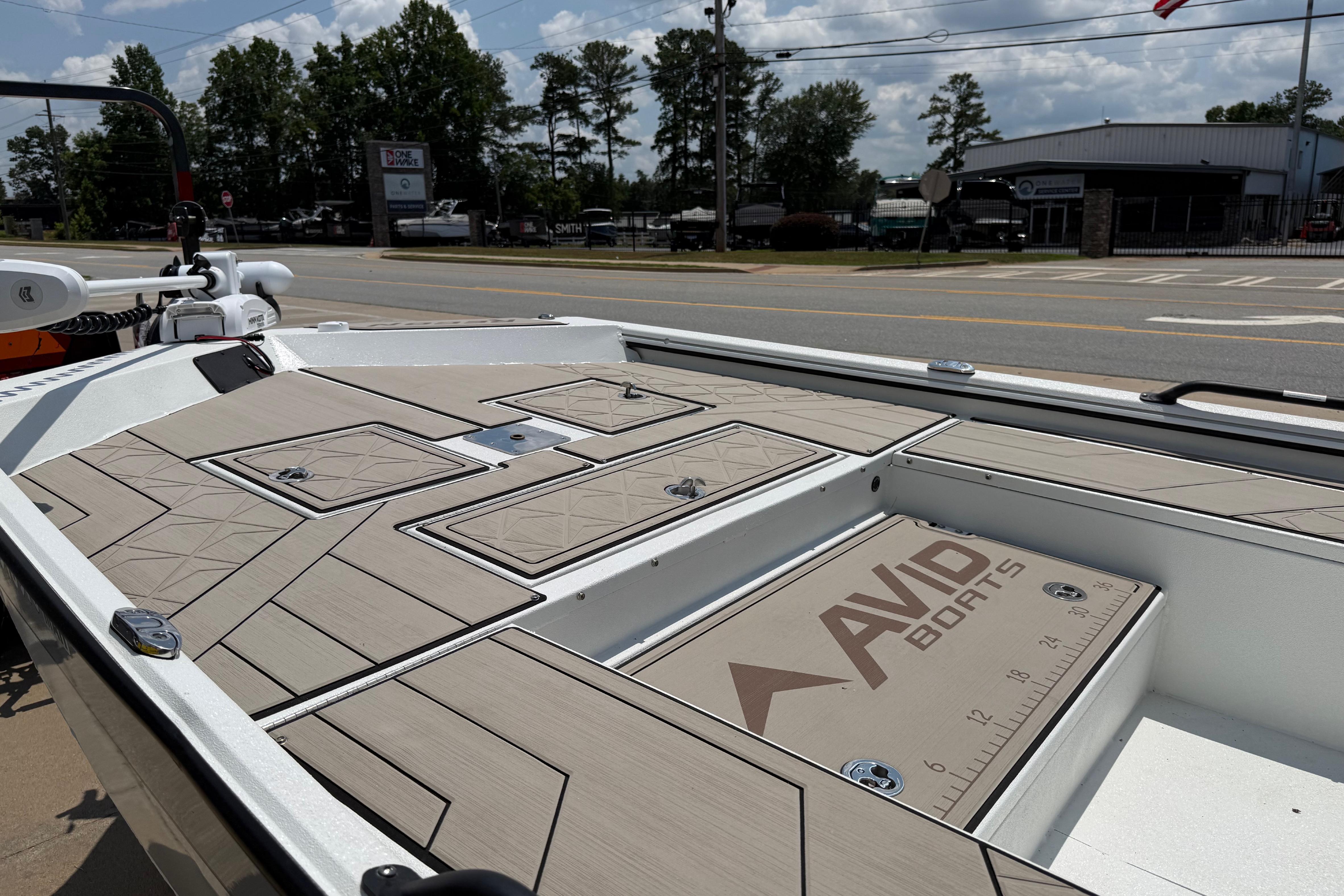 2025 Avid 22 Recon boat deck with storage compartments and branded ruler.