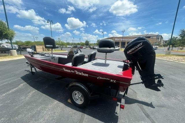 2026 Tracker Bass Tracker Classic XL boat with Mercury engine in parking lot.