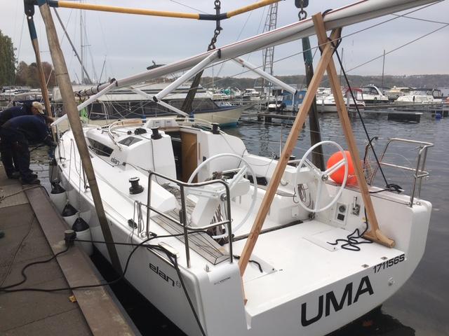 Sailboat Elan E3 2020 docked at marina, mast secured, with surrounding boats.